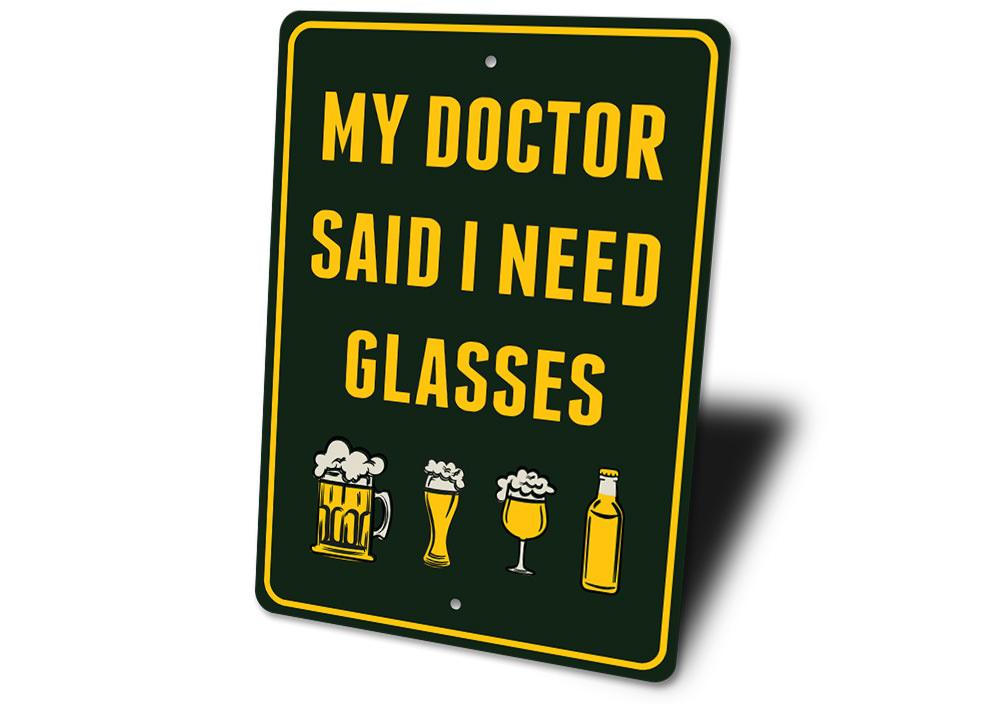 I Need Glasses Beer Sign made of durable aluminum, featuring humorous text and pre-drilled holes for easy mounting.