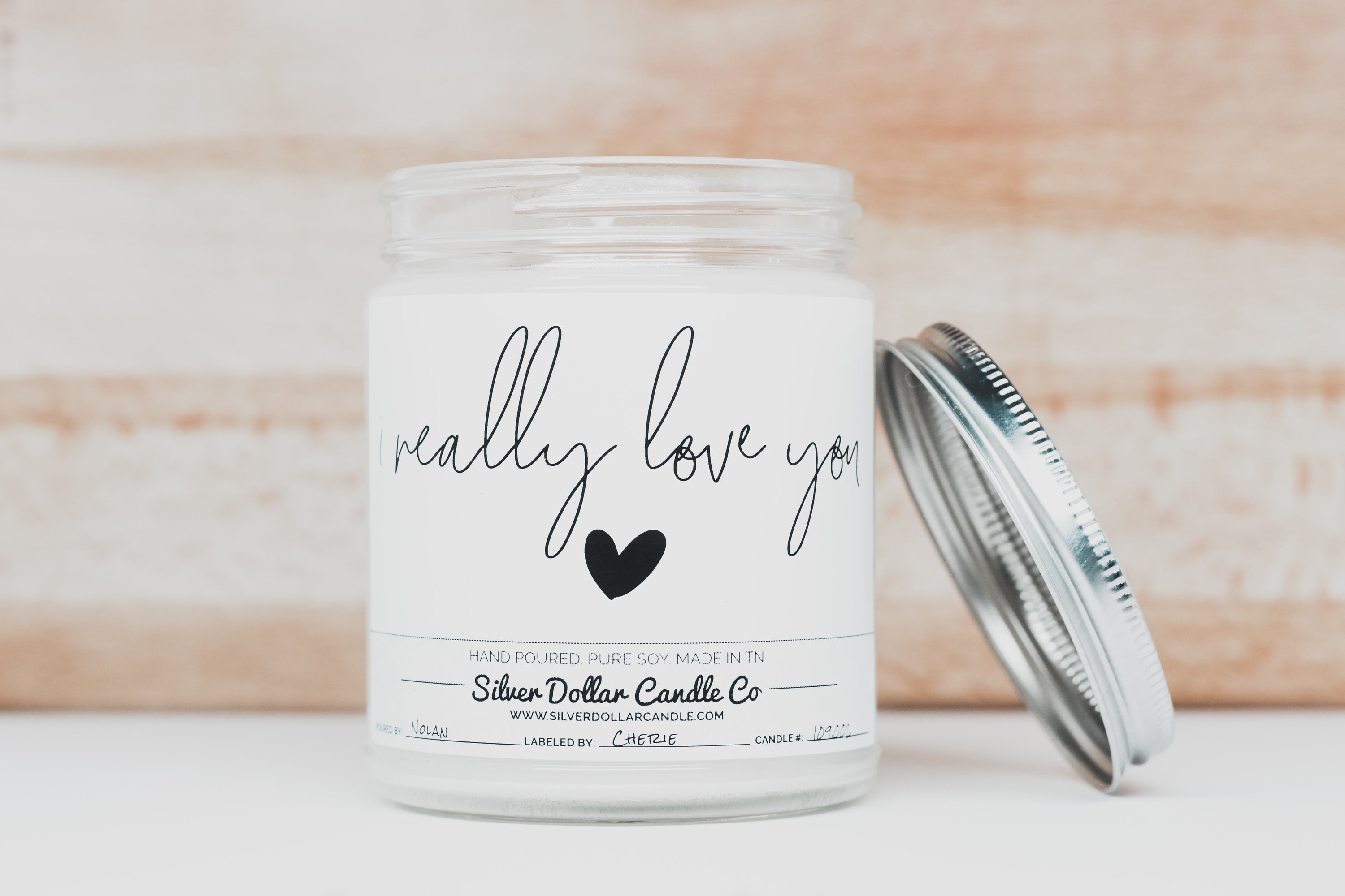 A beautifully designed 'I Really Love You' candle in an elegant box, showcasing its personalization option and scent variety.