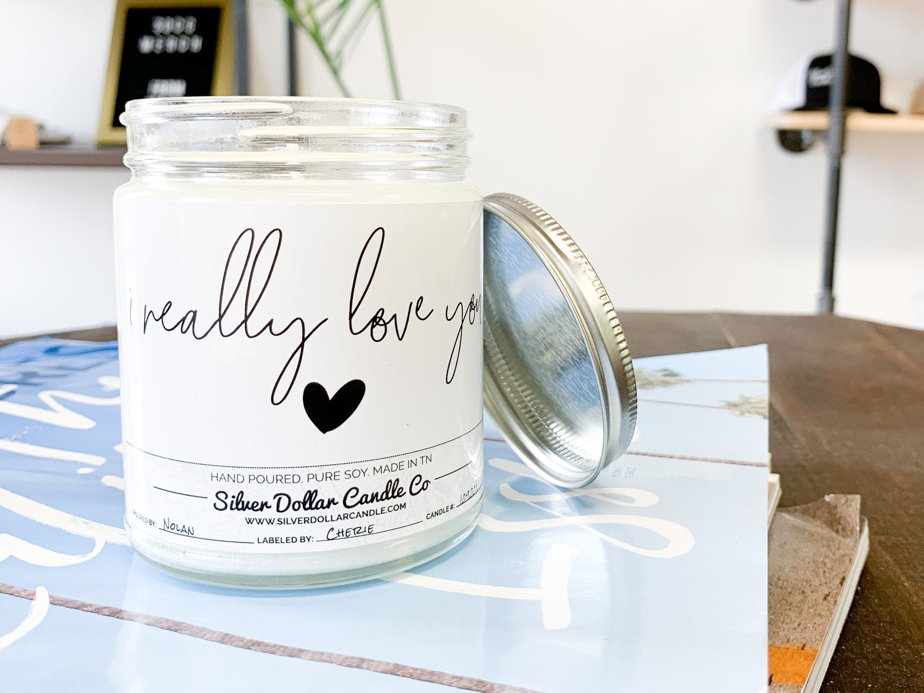 A beautifully designed 'I Really Love You' candle in an elegant box, showcasing its personalization option and scent variety.