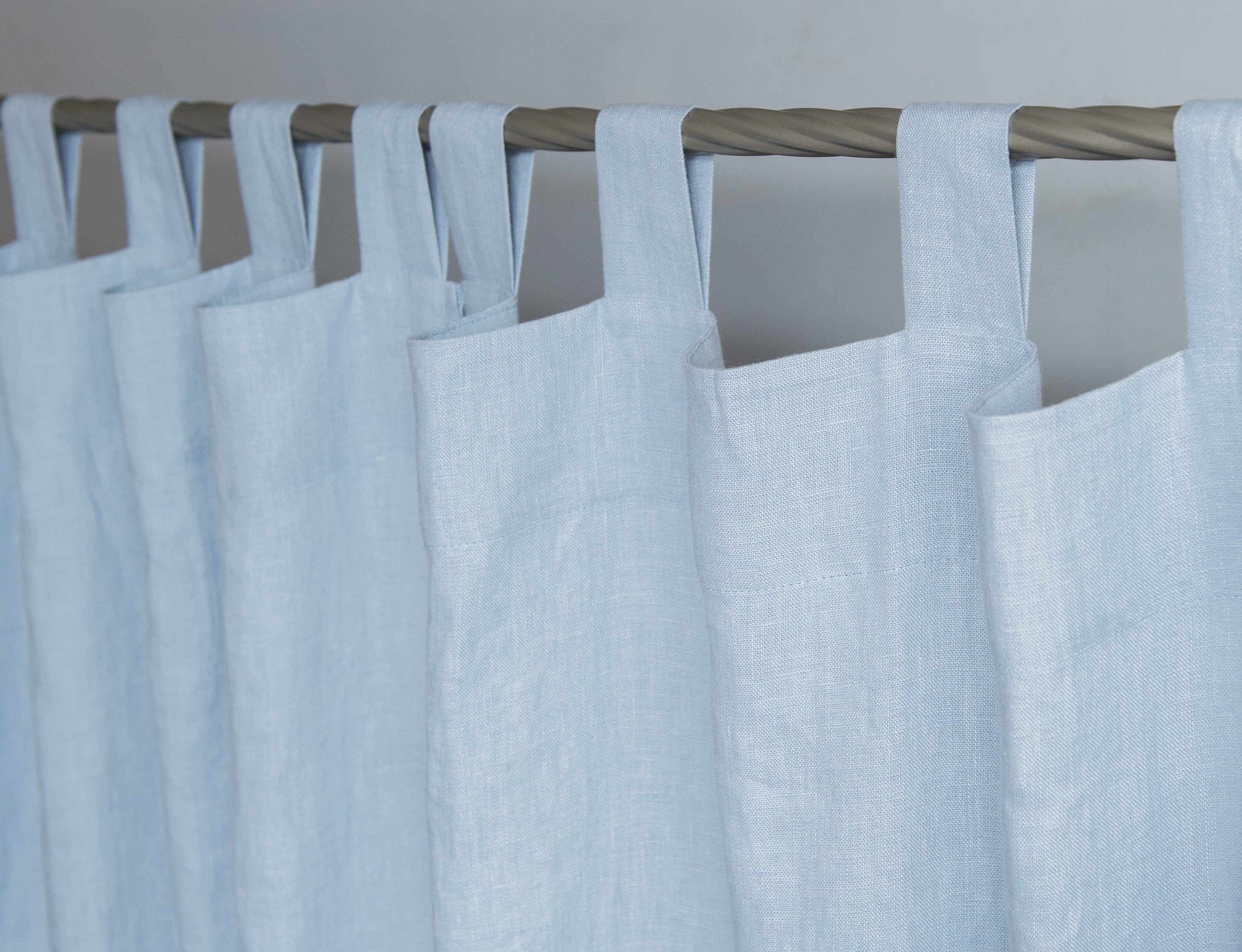 Ice Blue linen curtain with tab tops, showcasing a semi-sheer fabric that allows light to filter through elegantly.