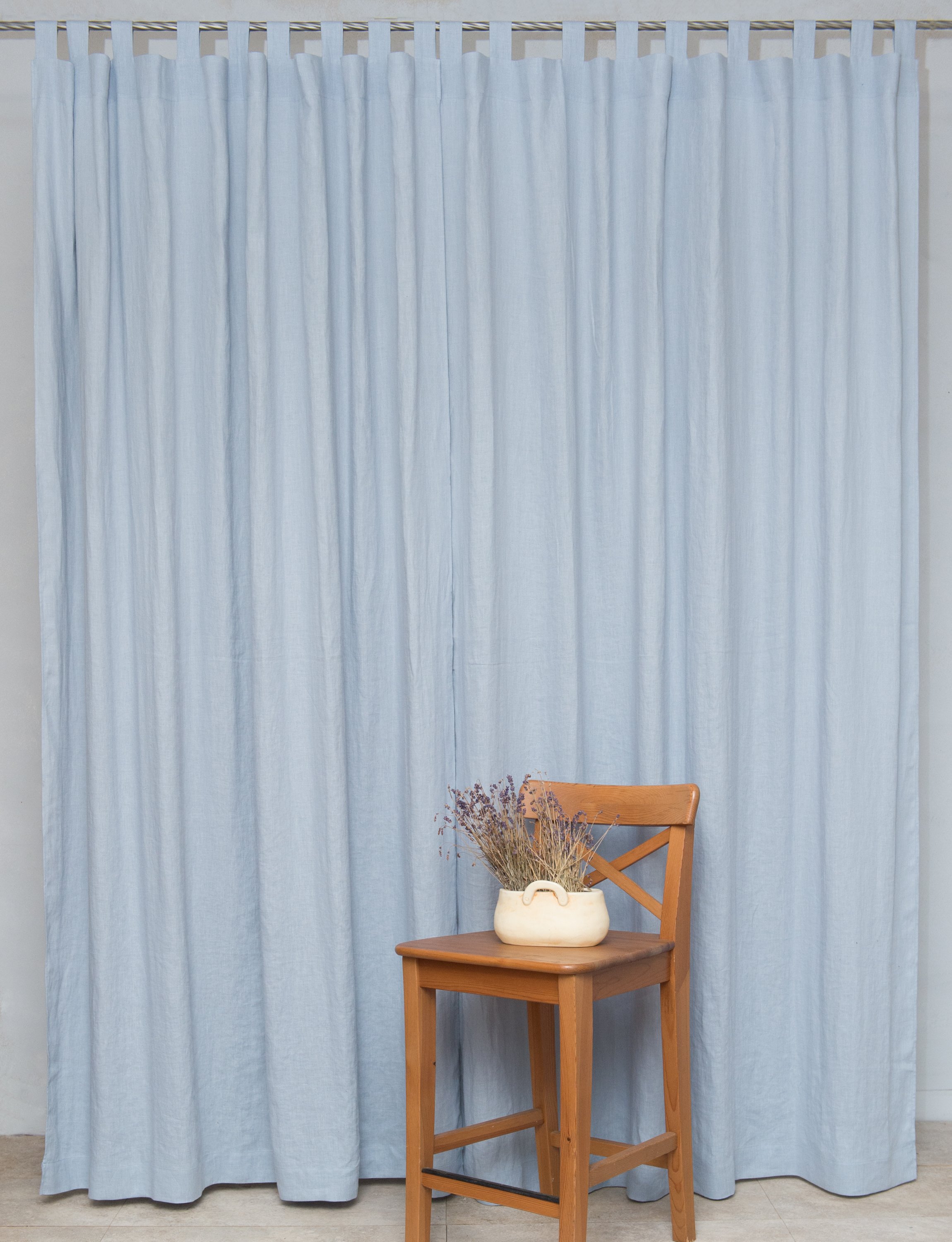 Ice Blue linen curtain with tab tops, showcasing a semi-sheer fabric that allows light to filter through elegantly.