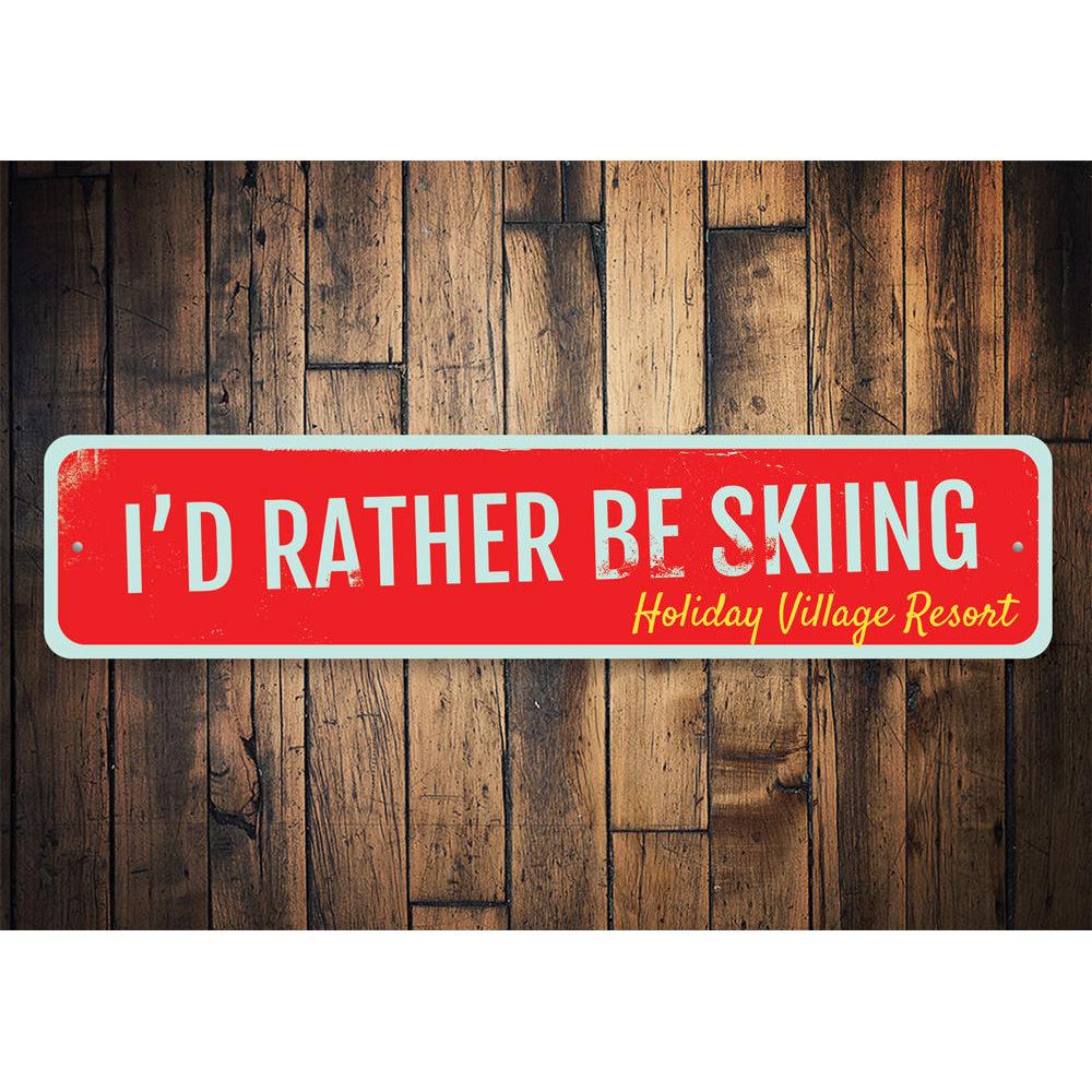 A decorative metal sign that reads 'I'd Rather Be Skiing', featuring a stylish design perfect for ski enthusiasts.