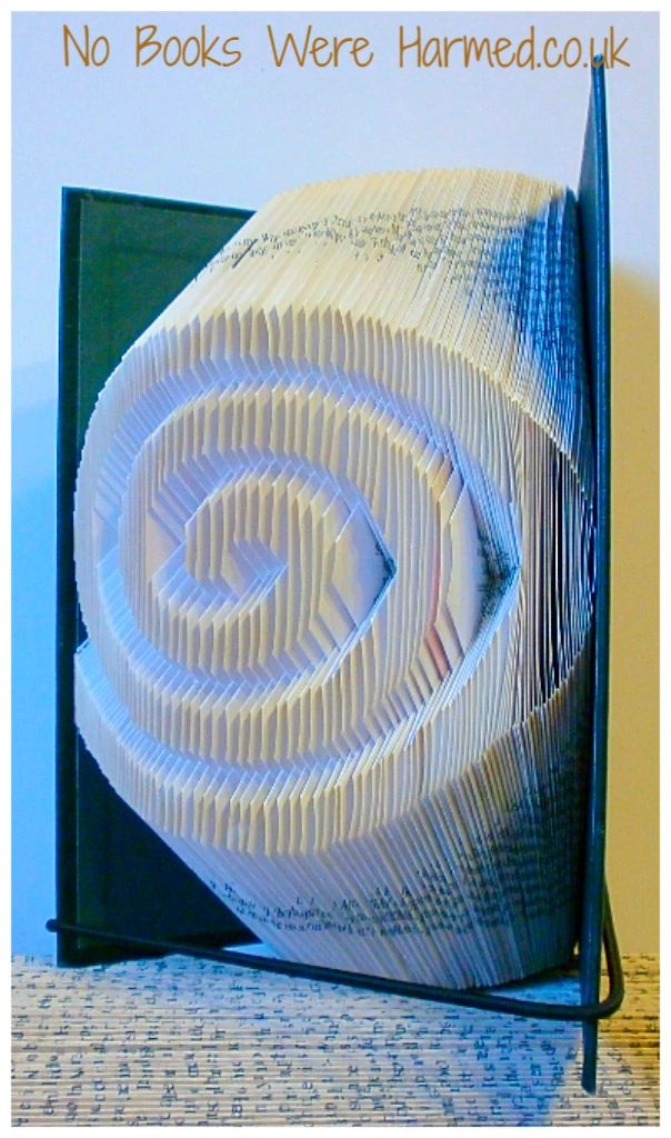 Hand-folded Infinite Spiral book art made from vintage books, showcasing intricate folds and unique design.