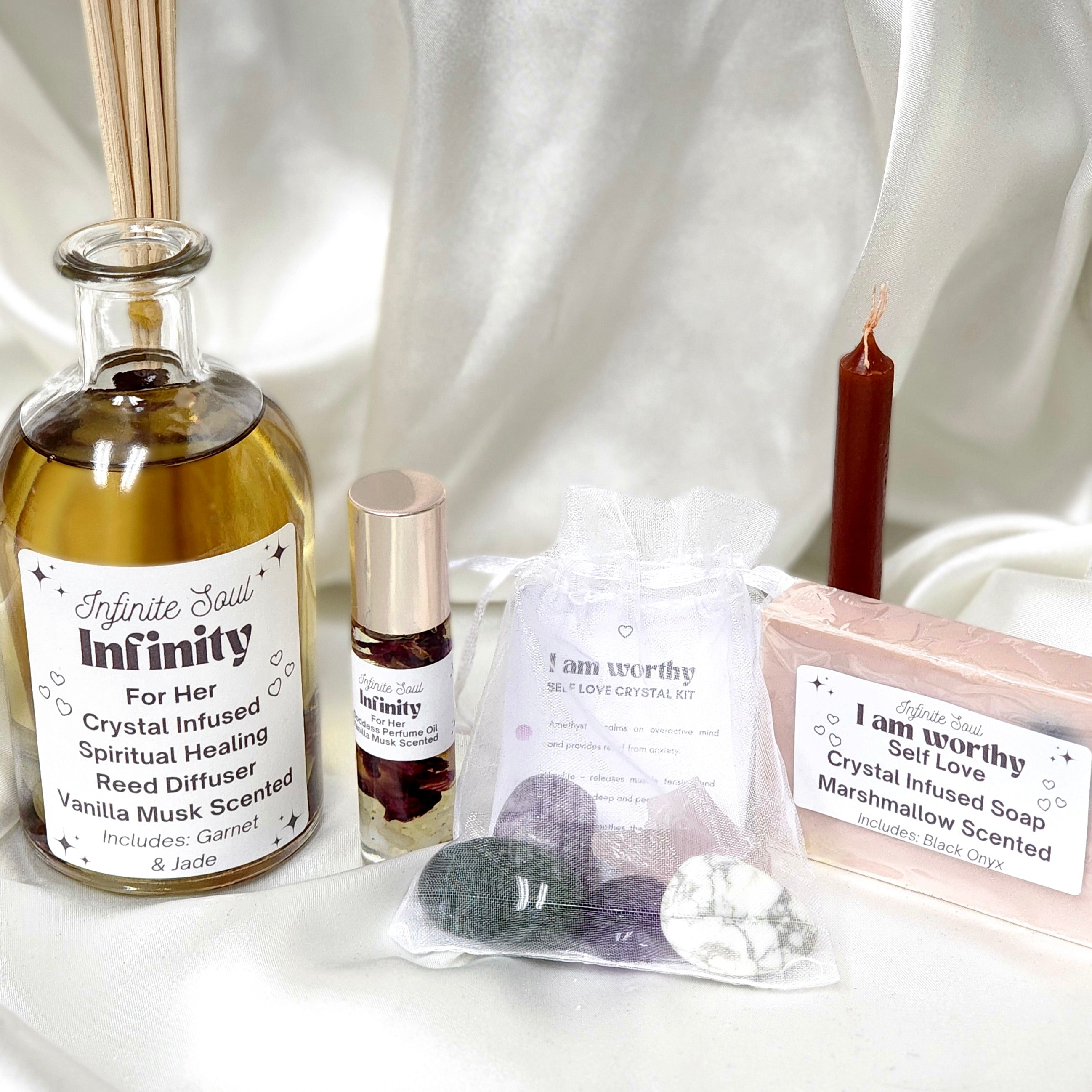 Infinity: For Her Bundle featuring a crystal infused candle, soap, manifestation candle, healing kit, and goddess perfume oil, all designed for spiritual healing.