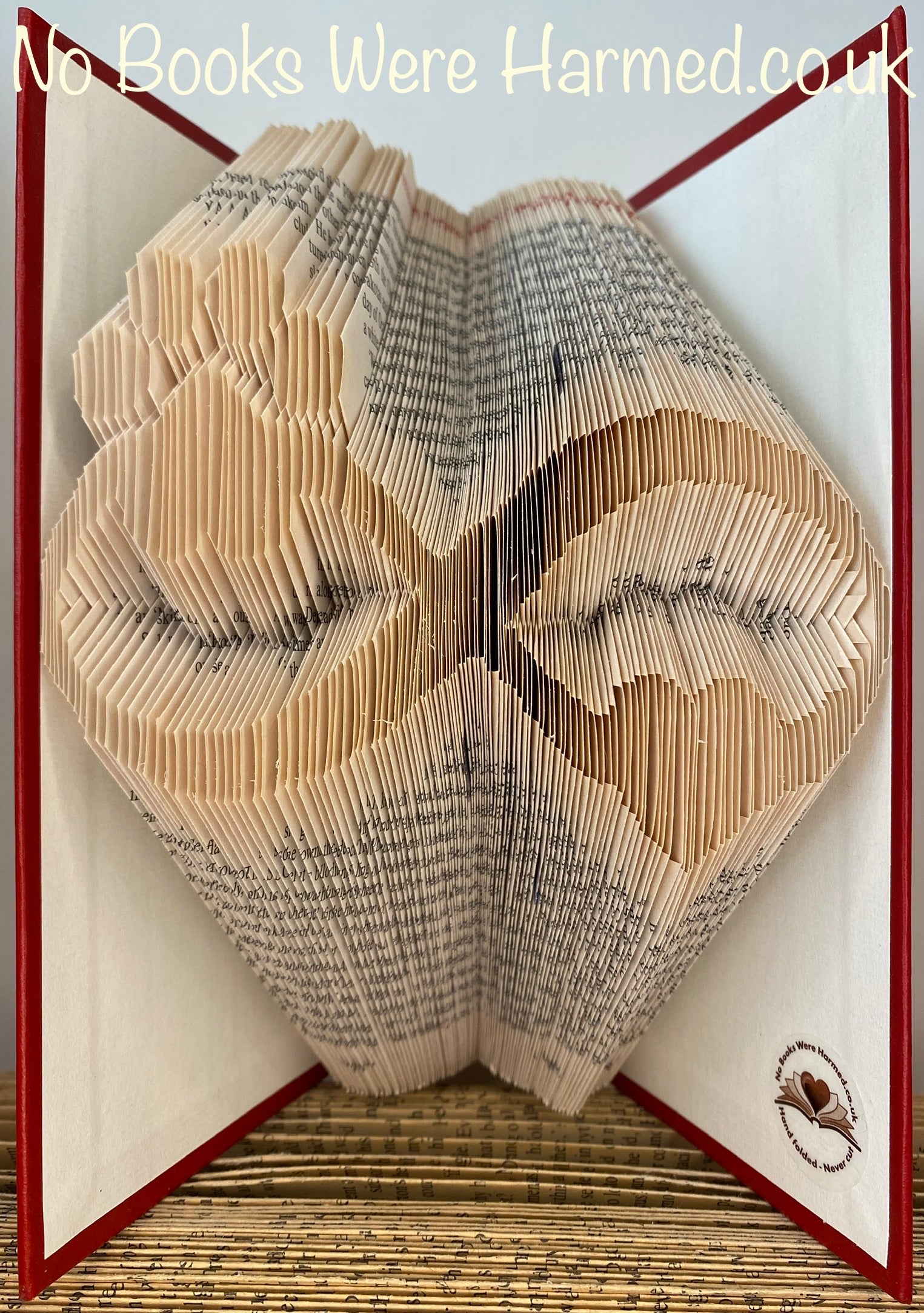 Handcrafted Infinity Heart and Paw Print art made from vintage book pages, showcasing intricate folds and unique design.