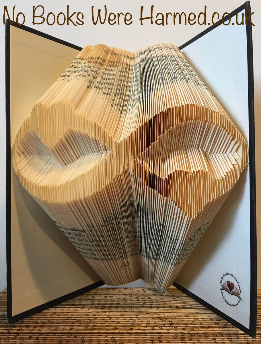 A beautifully crafted Infinity Hearts art piece made from hand-folded pages of vintage books, showcasing intricate designs and unique colors.