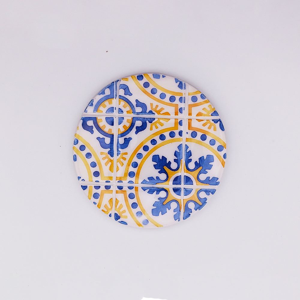 Hand-made and hand-painted ceramic tile cup pad inspired by the Island of Madeira, showcasing vibrant colors and intricate designs.