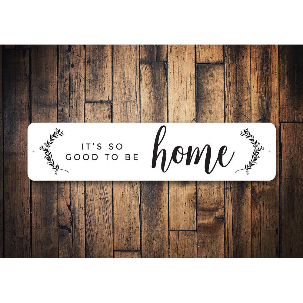 A decorative metal sign reading 'It's So Good To Be Home', showcasing quality aluminum craftsmanship and customizable options.