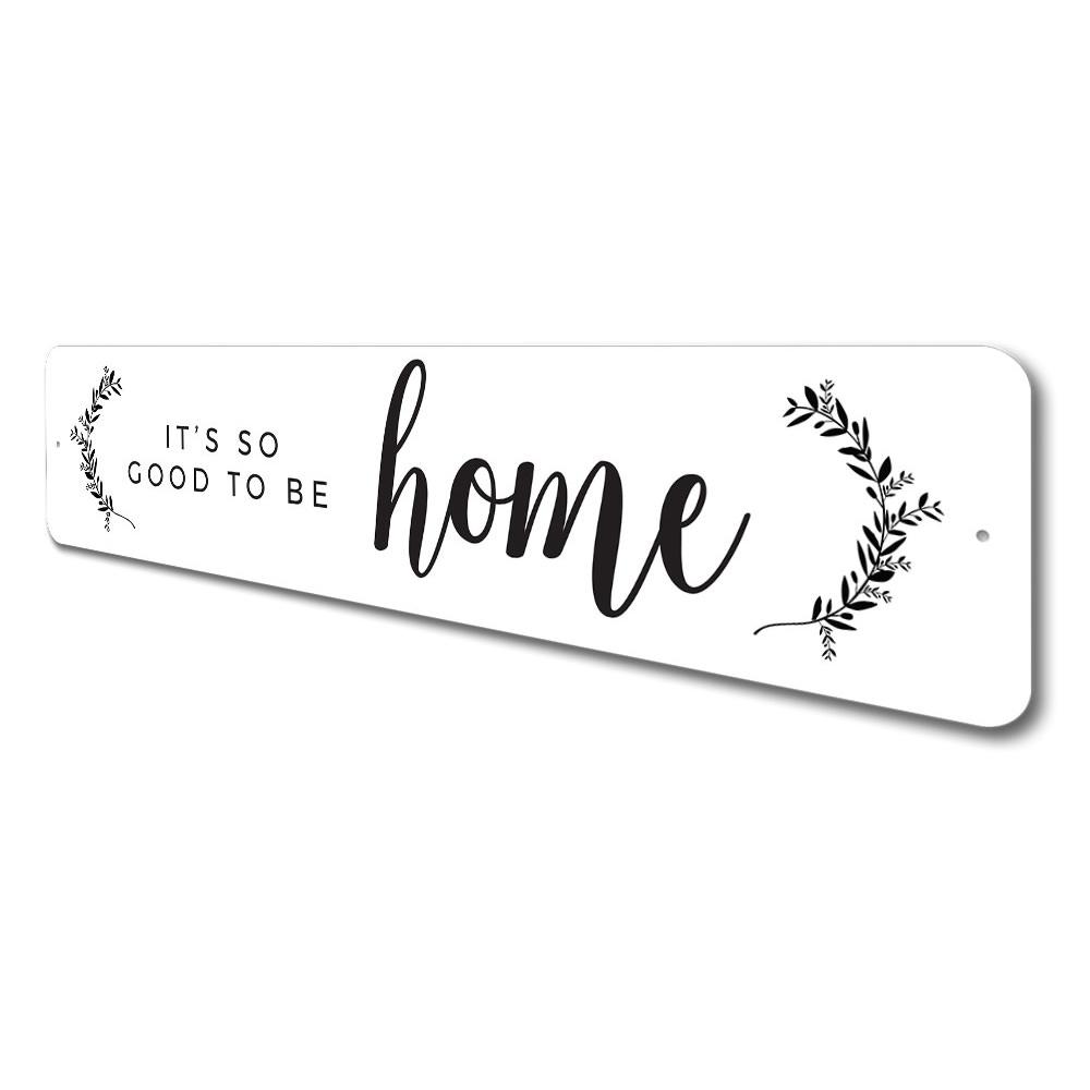 A decorative metal sign reading 'It's So Good To Be Home', showcasing quality aluminum craftsmanship and customizable options.