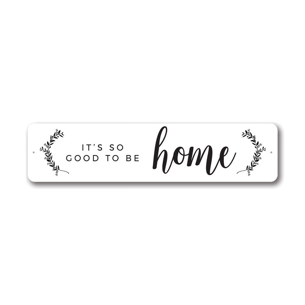 A decorative metal sign reading 'It's So Good To Be Home', showcasing quality aluminum craftsmanship and customizable options.