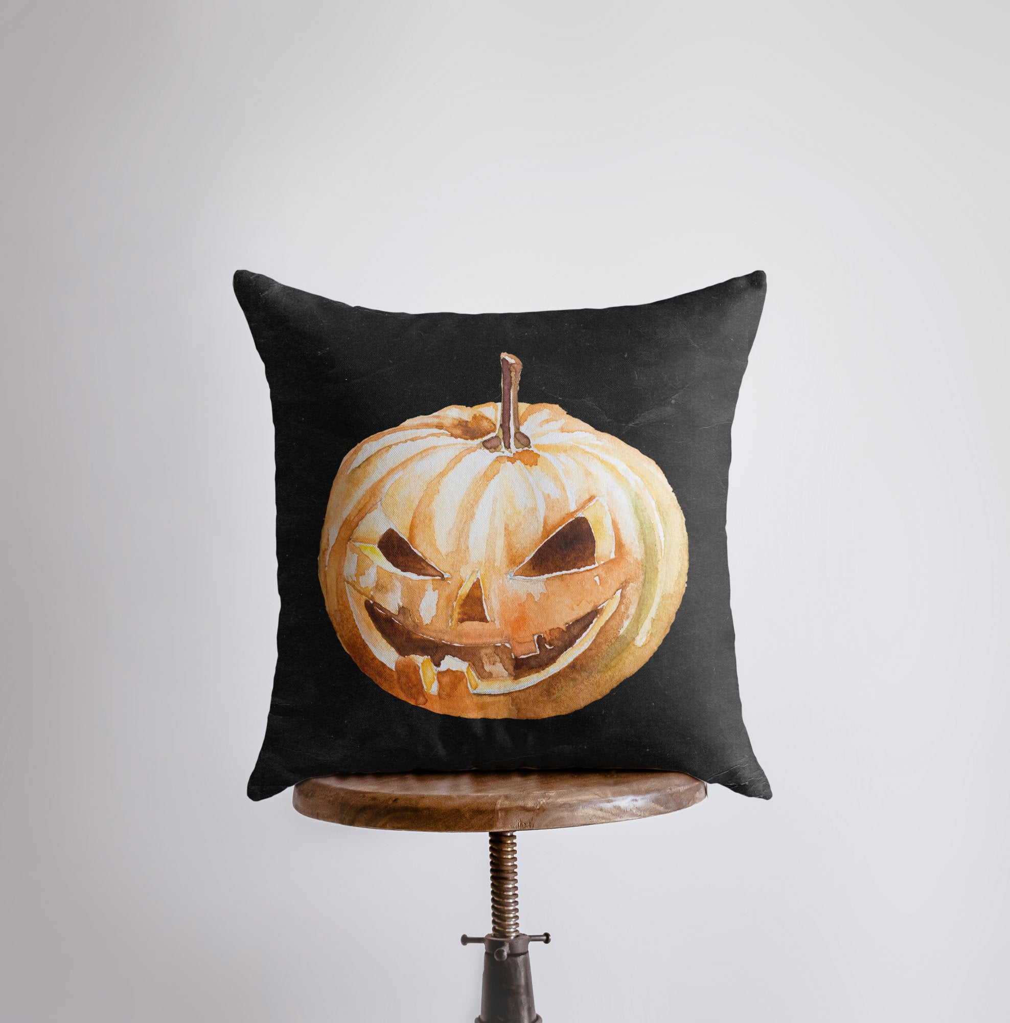 A vibrant Jack O Lantern Pillow Cover featuring friendly pumpkin faces, perfect for Halloween and fall décor, showcasing its double-sided design.