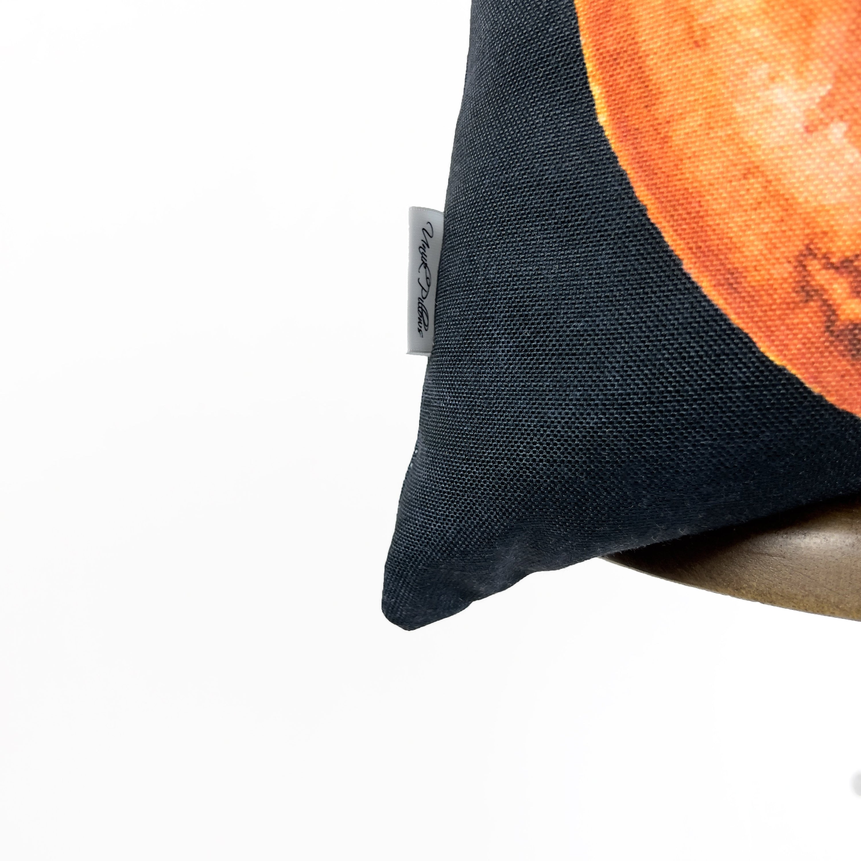 A vibrant Jack O Lantern Pillow Cover featuring friendly pumpkin faces, perfect for Halloween and fall décor, showcasing its double-sided design.