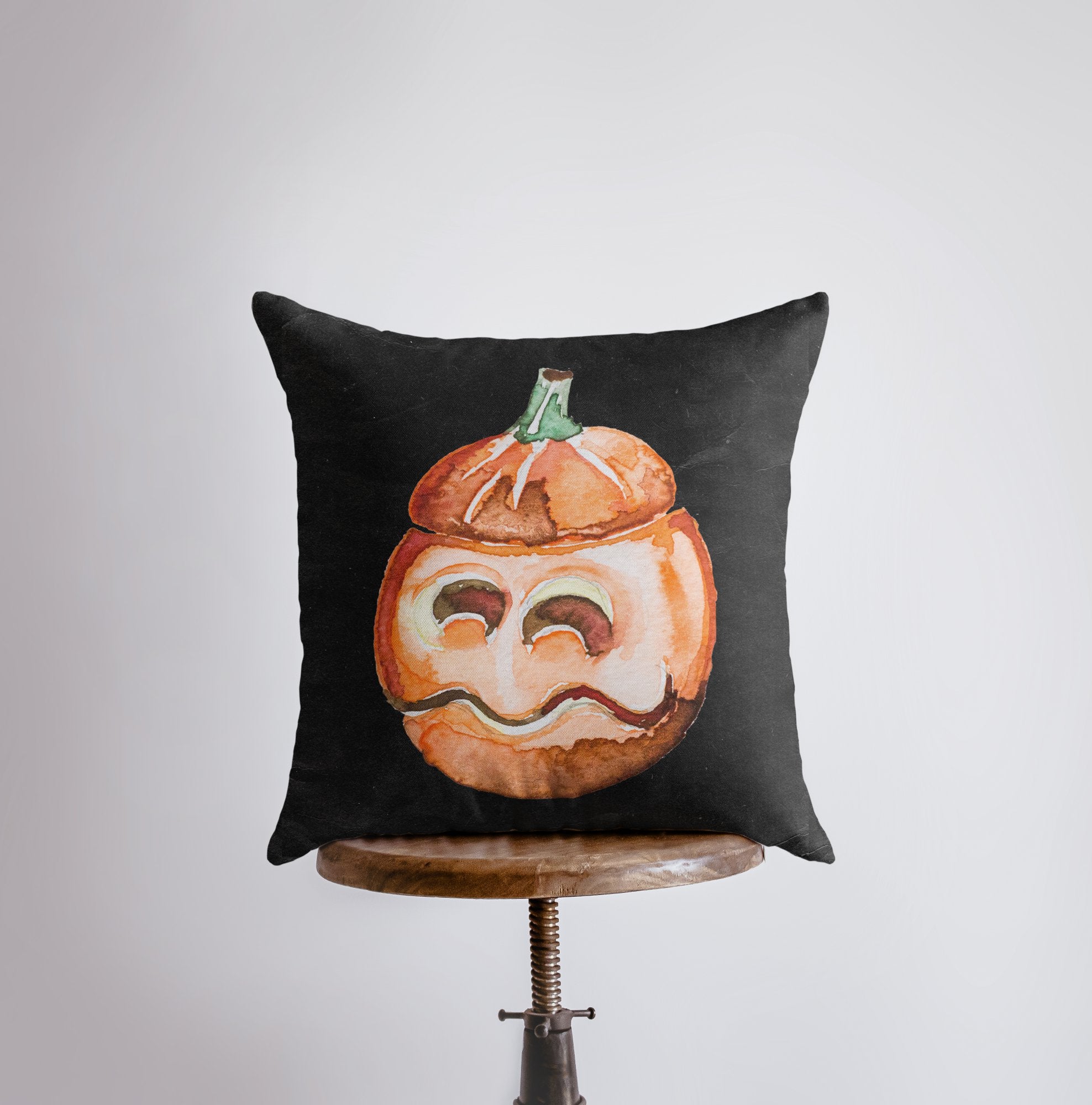 A vibrant Jack O Lantern Pillow Cover featuring a cheerful pumpkin face, perfect for Halloween and fall décor, showcasing its double-sided design.