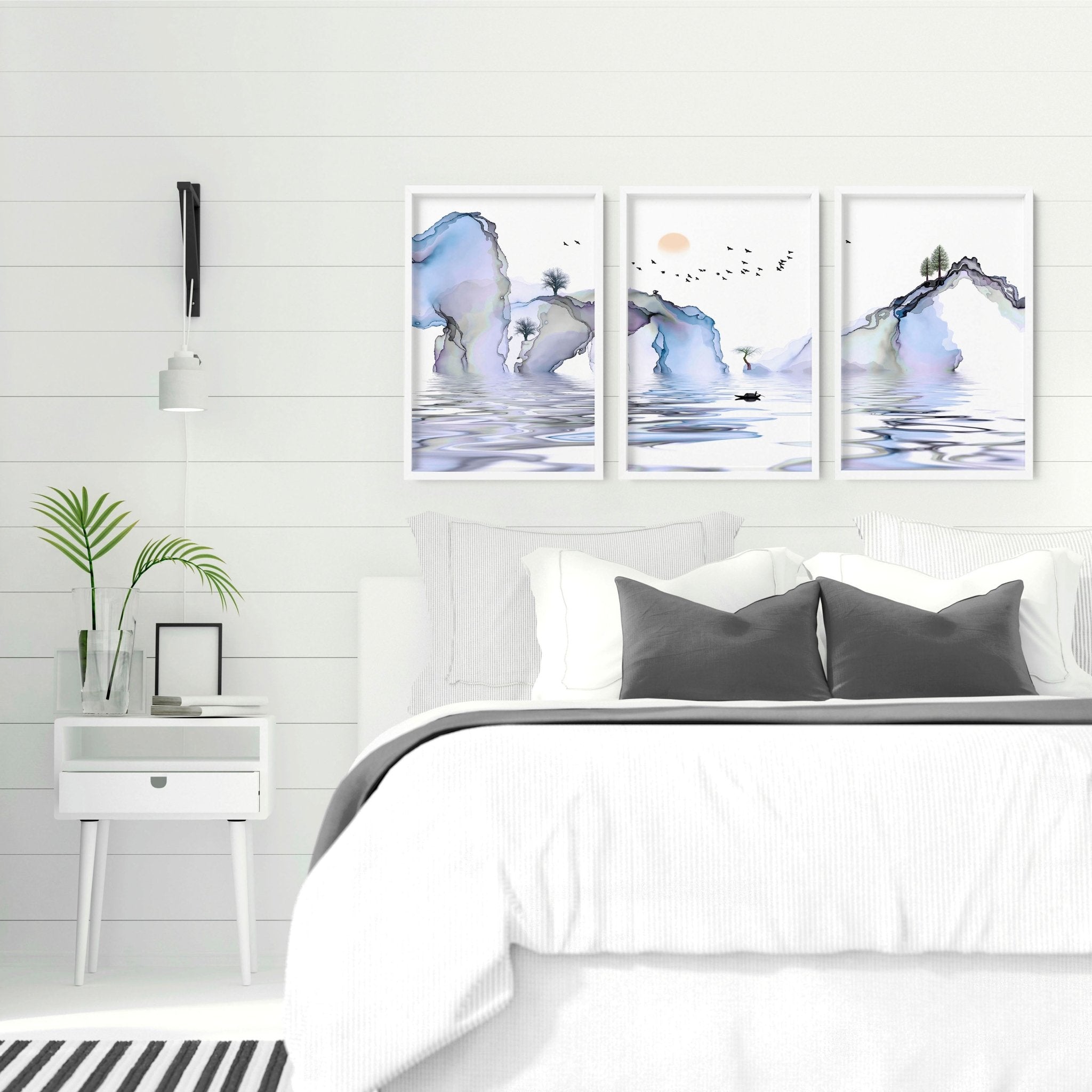 Set of 3 framed wall art prints featuring light blue ethereal Japanese landscapes, perfect for creating a serene bedroom atmosphere.