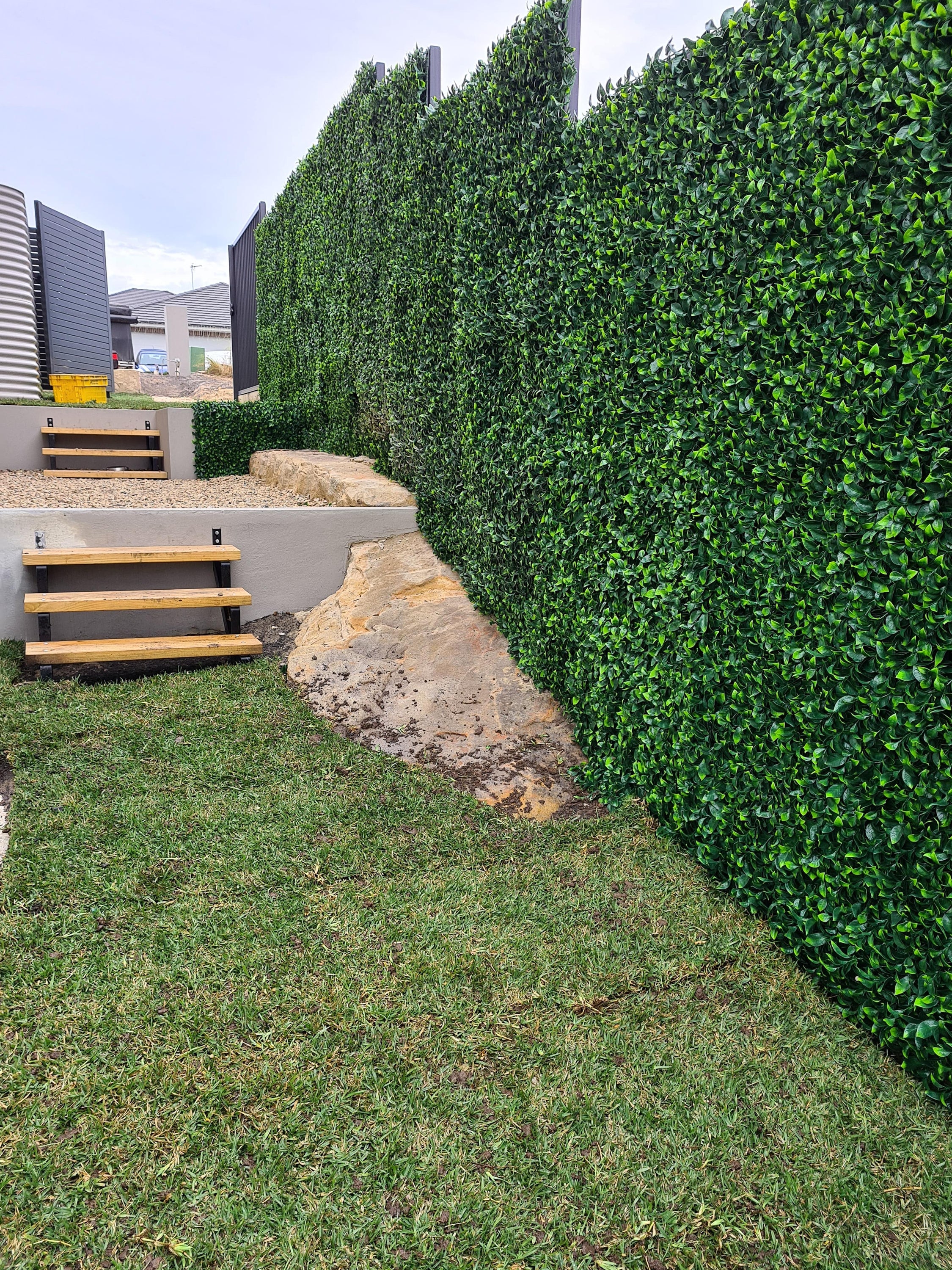 Jasmine Artificial Hedge Screen, a lush green wall panel, showcasing realistic foliage for indoor and outdoor use.