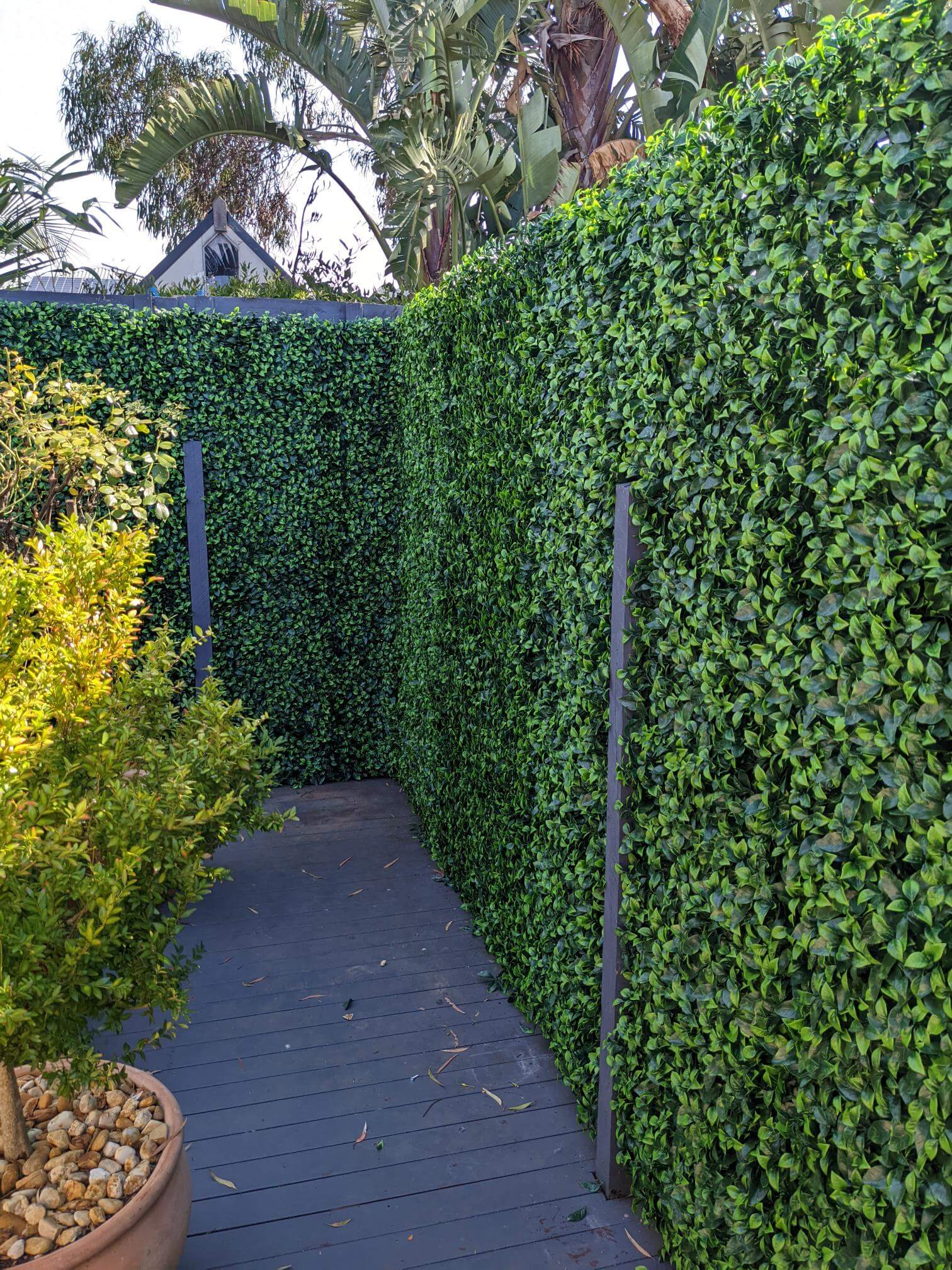 Jasmine Artificial Hedge Screen, a lush green wall panel, showcasing realistic foliage for indoor and outdoor use.