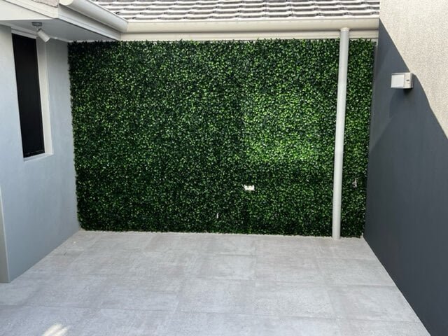 Jasmine Artificial Hedge Screen, a lush green wall panel, showcasing realistic foliage for indoor and outdoor use.