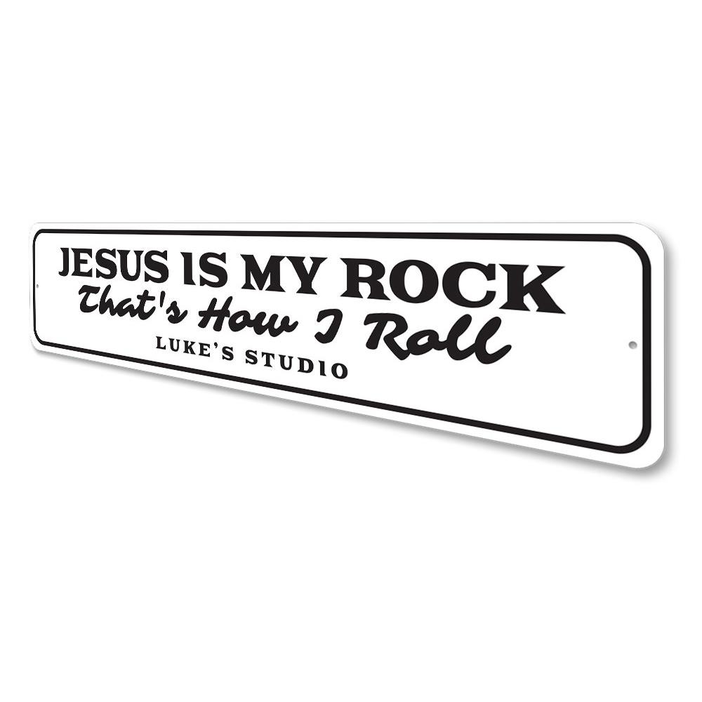 A decorative metal sign featuring the phrase 'Jesus is My Rock', showcasing a beautiful design suitable for home decor.