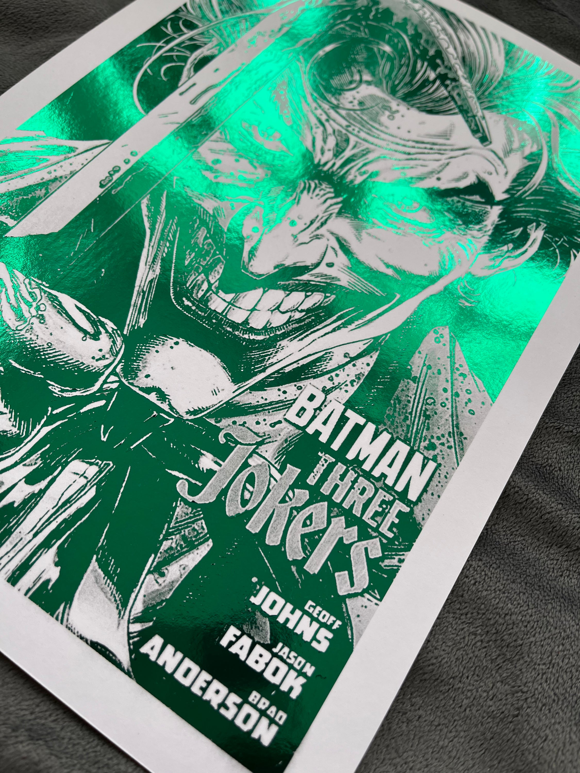 Vibrant green Joker foil print featuring the Clown Prince of Crime with an iconic smile.