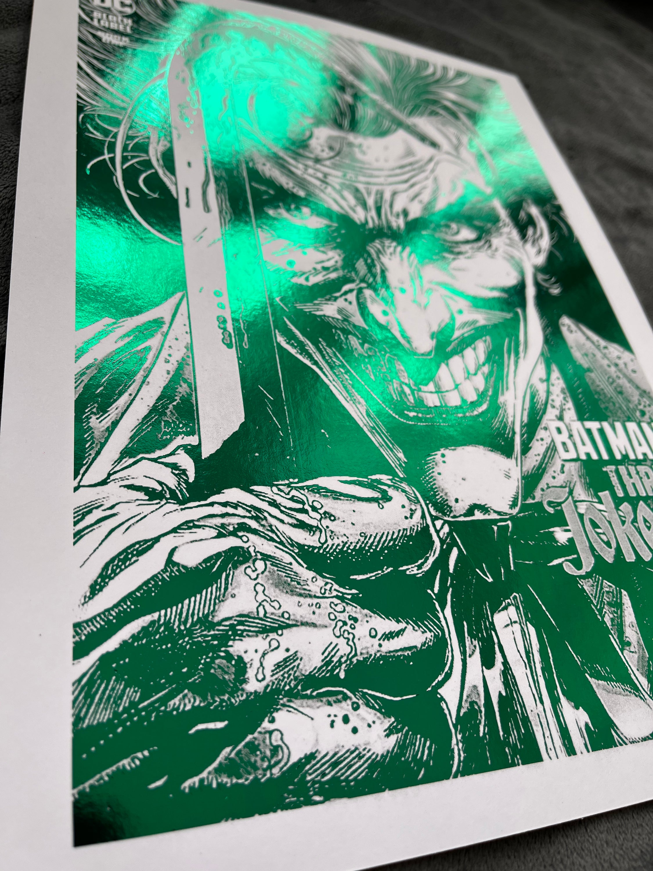 Vibrant green Joker foil print featuring the Clown Prince of Crime with an iconic smile.