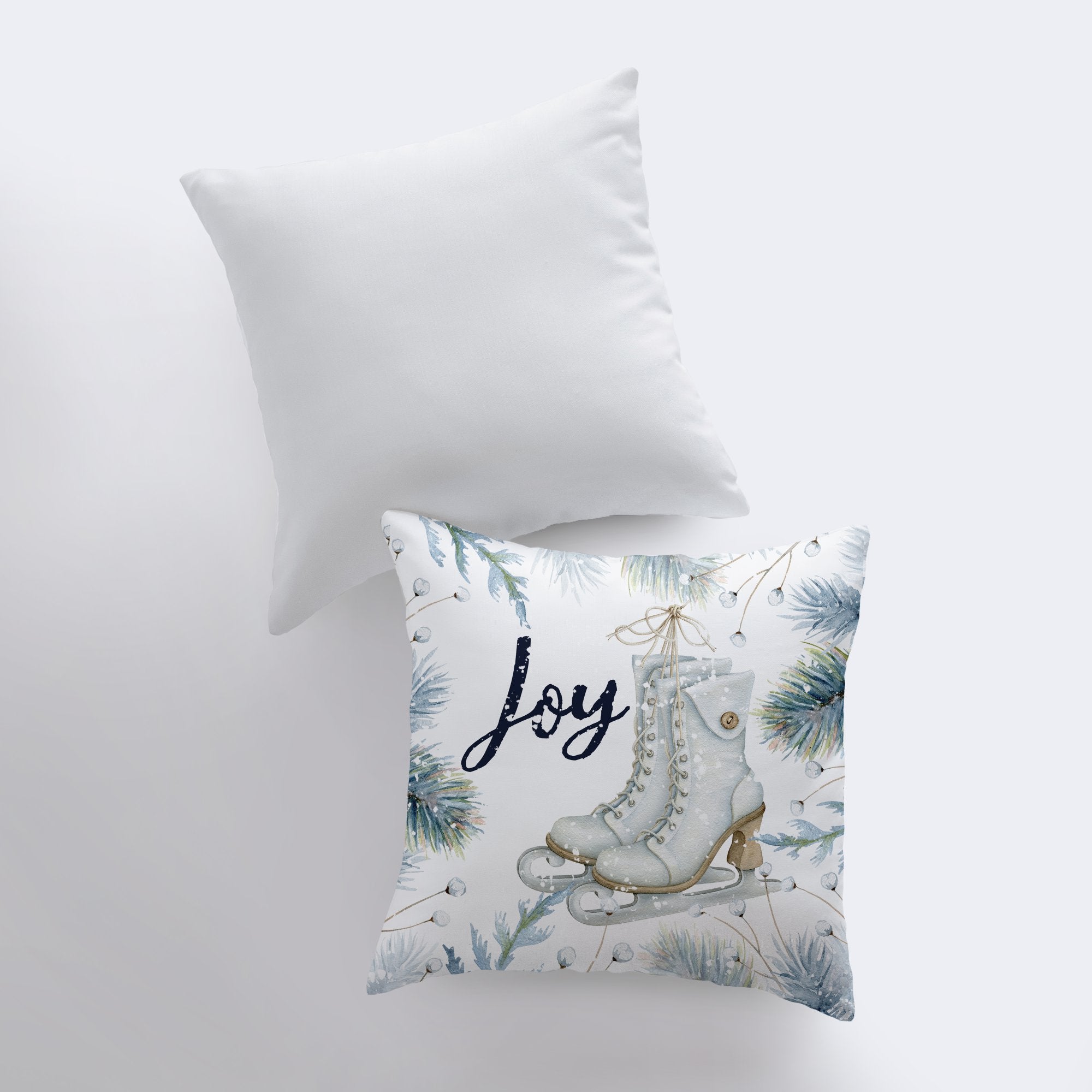 Joy Ice Skating Throw Pillow featuring white ice skates and cursive 'Joy' text with wintergreen branches, perfect for winter decor.