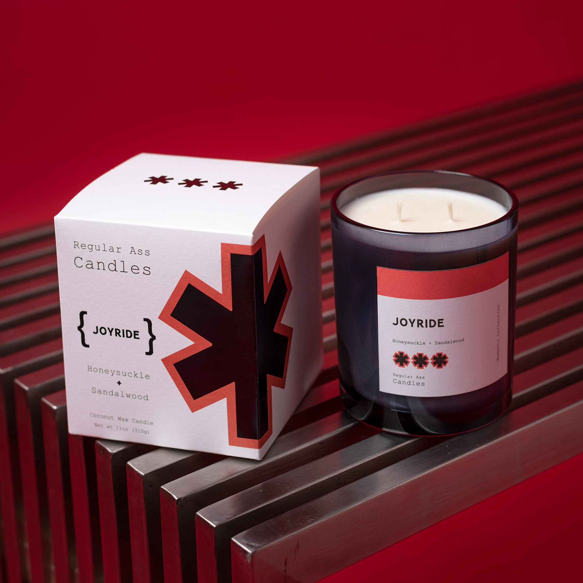 Joyride Honeysuckle + Sandalwood 11oz Candle in a stylish jar, showcasing its eco-friendly design and inviting floral scent.