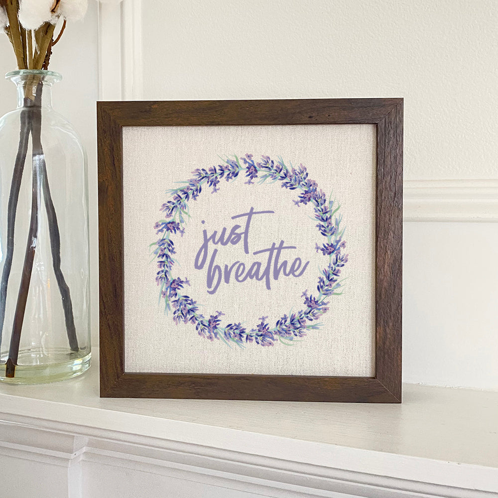 Just Breathe Framed Sign with a stylized wood frame and linen-look background, perfect for home decor.