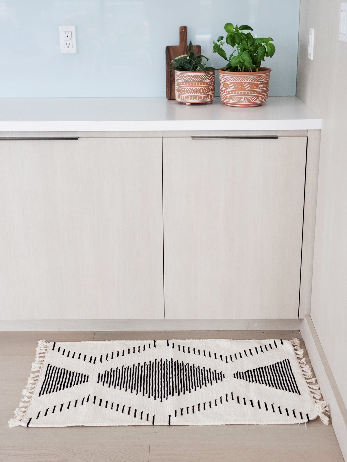 Kalo Floor Mat made from recycled chenille scraps, featuring a unique black and white pattern, soft texture, and handcrafted design.