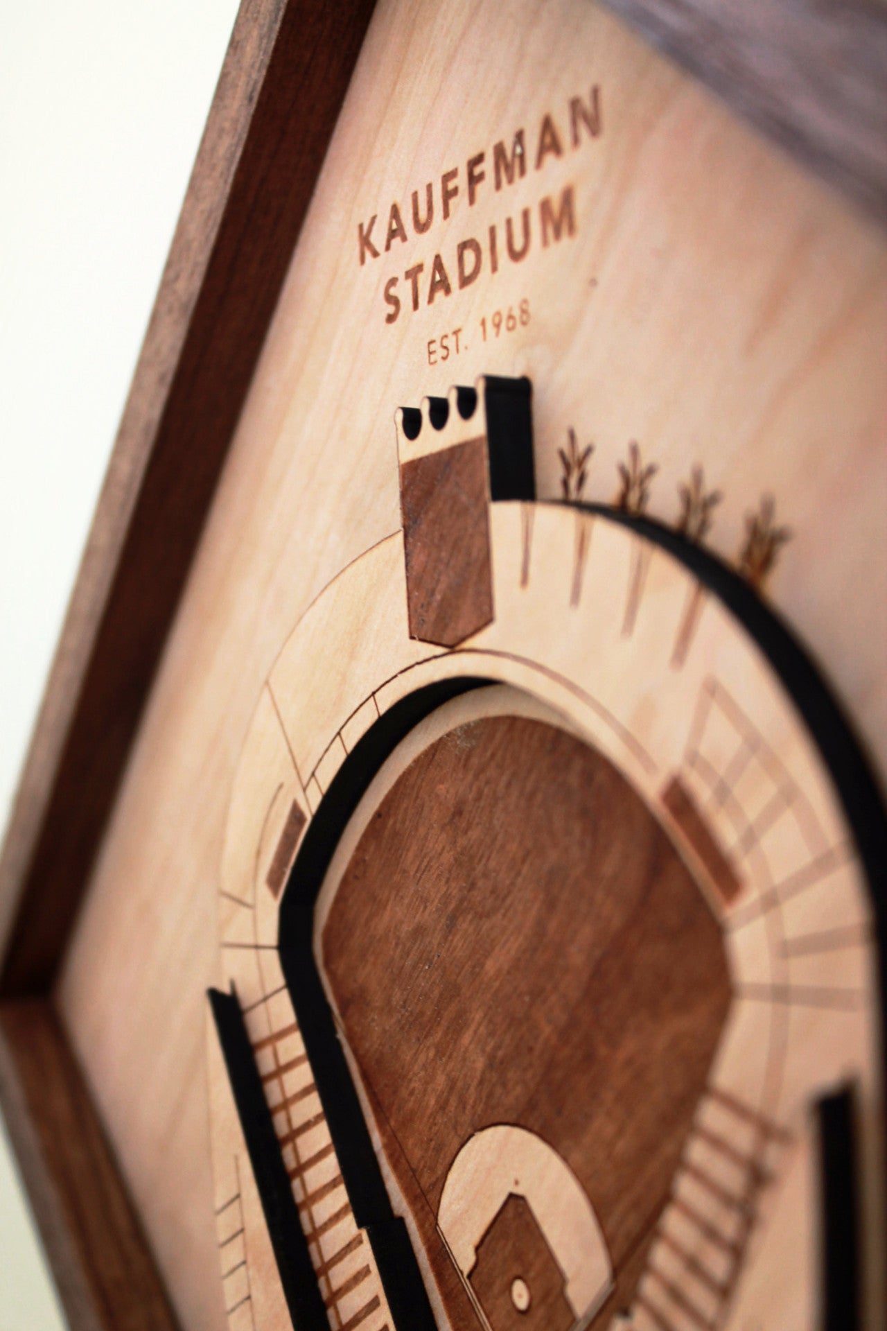 Intricate wooden art piece of Kauffman Stadium featuring detailed scoreboard and laser-etched fountains, framed in black walnut.