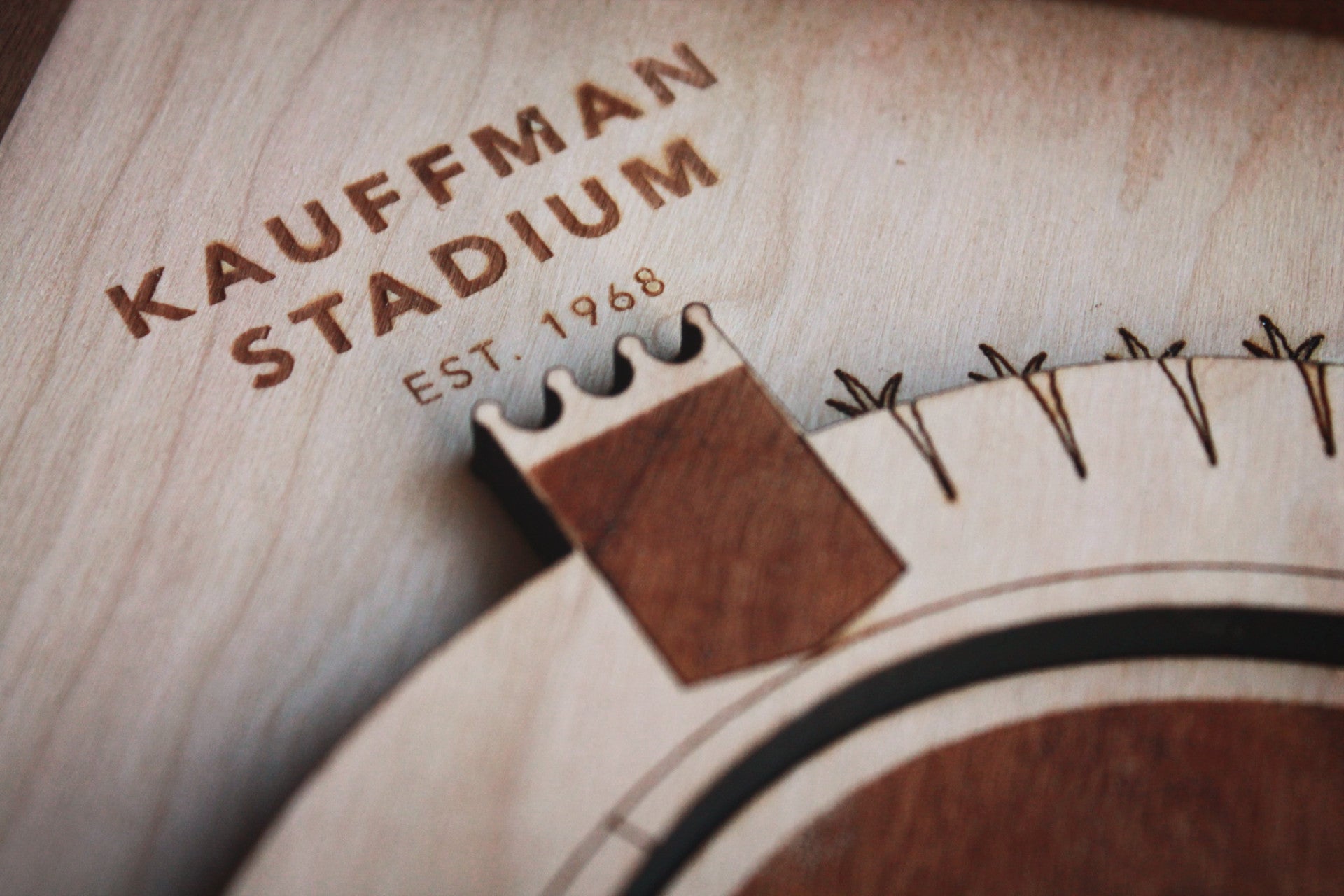 Intricate wooden art piece of Kauffman Stadium featuring detailed scoreboard and laser-etched fountains, framed in black walnut.