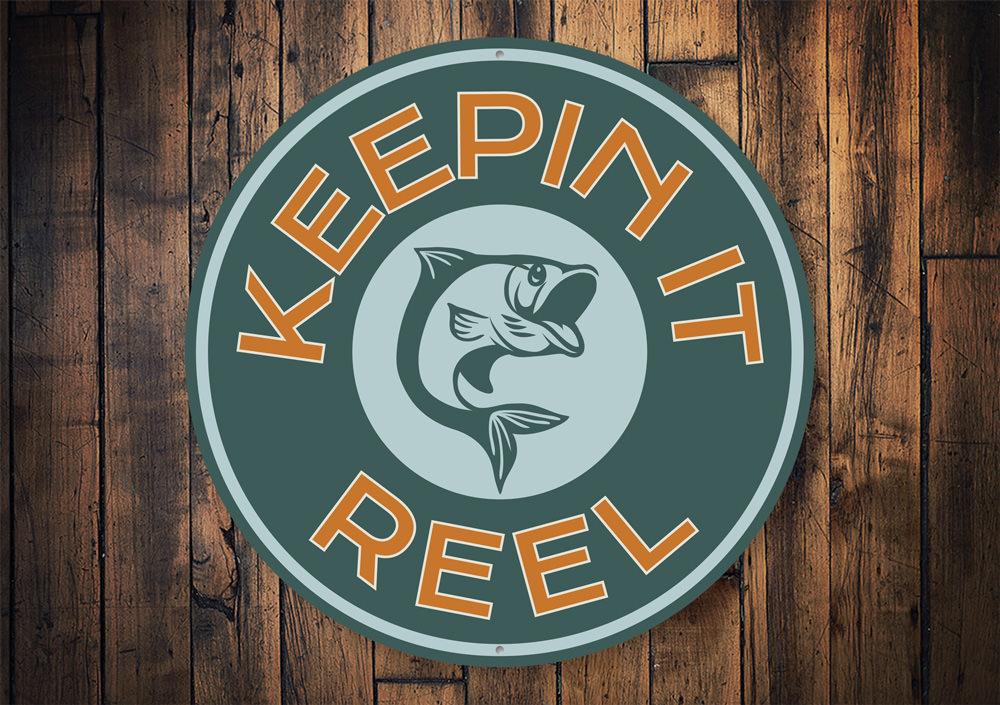 Keepin it Reel Sign made of high-quality aluminum, showcasing a lake theme, perfect for lakehouses and outdoor decor.