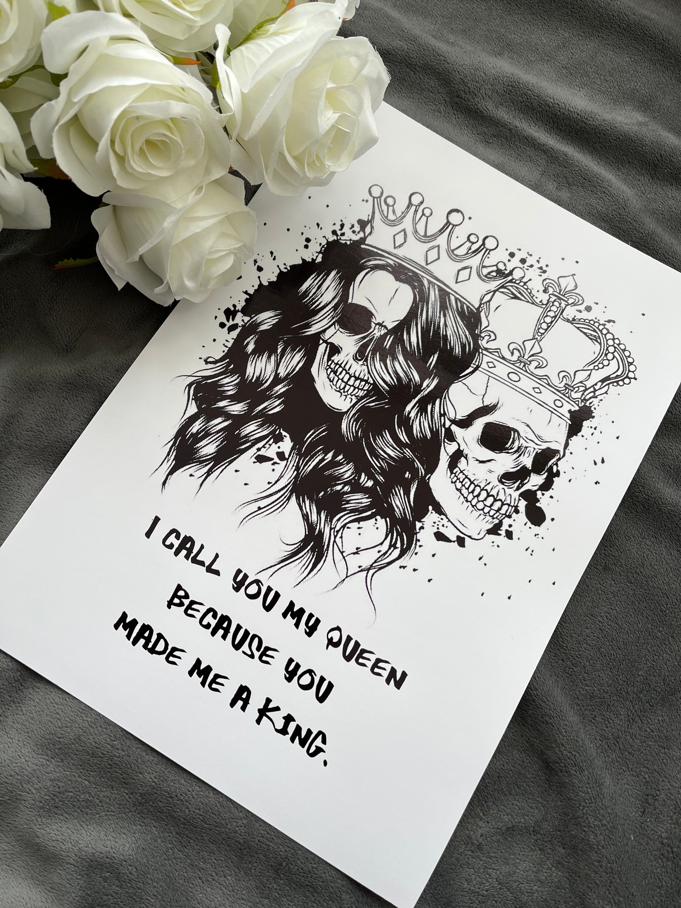 King & Queen Skull Foil Print featuring male and female skulls with crowns, showcasing intricate black foil details.