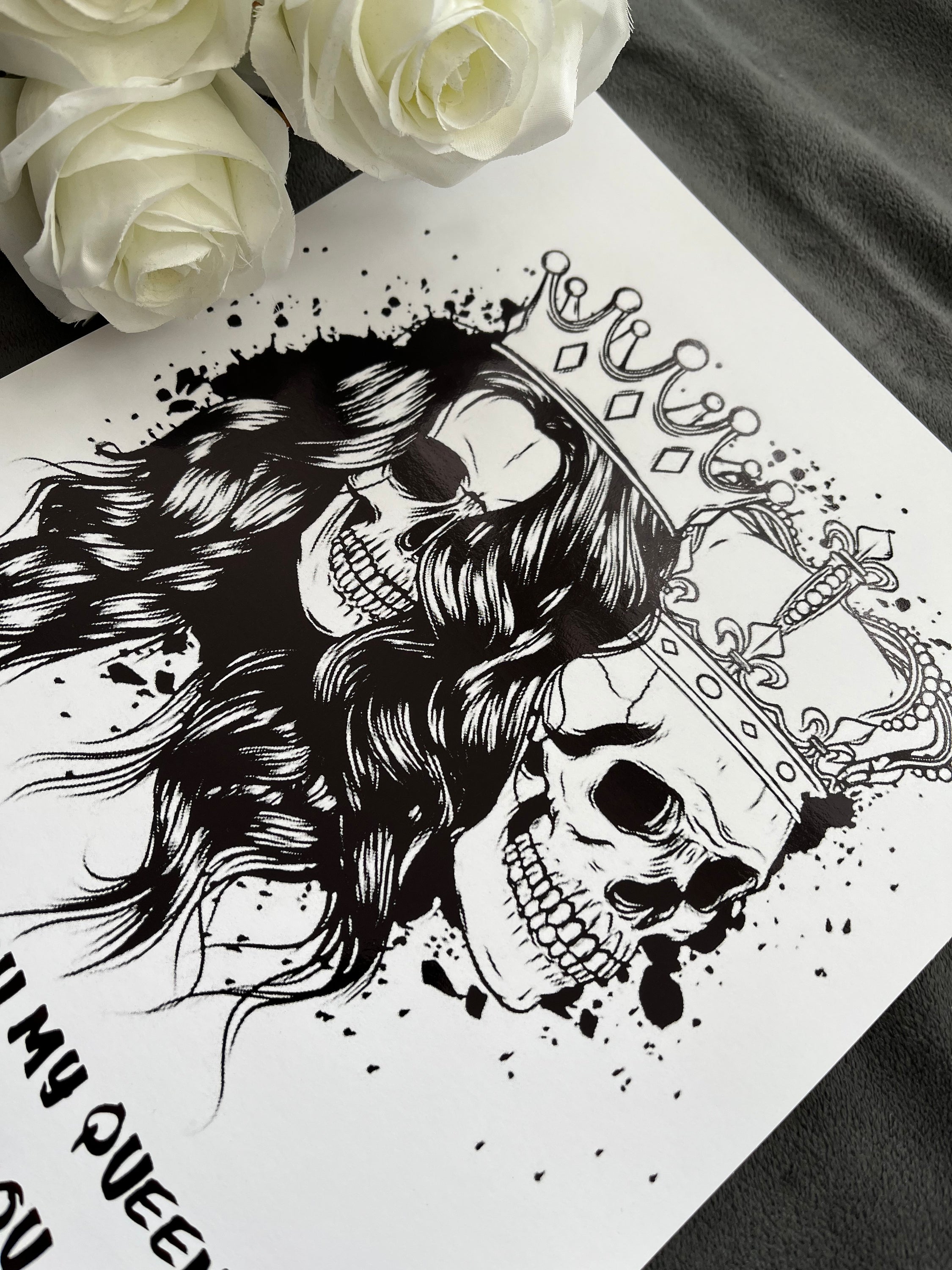 King & Queen Skull Foil Print featuring male and female skulls with crowns, showcasing intricate black foil details.