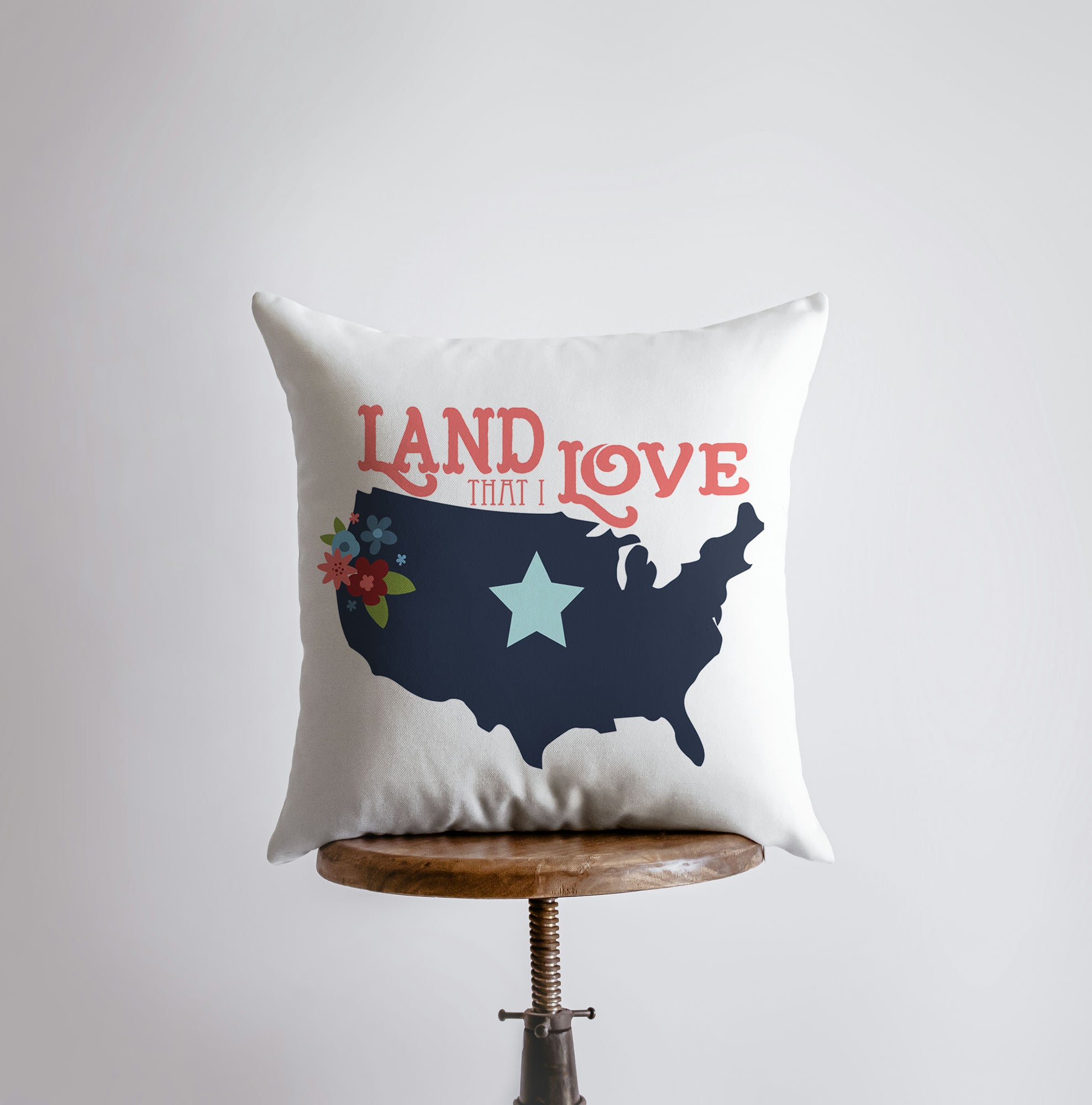 Handmade 'Land that I Love' pillow cover featuring a map of America and blue star design on the back, perfect for home decor.