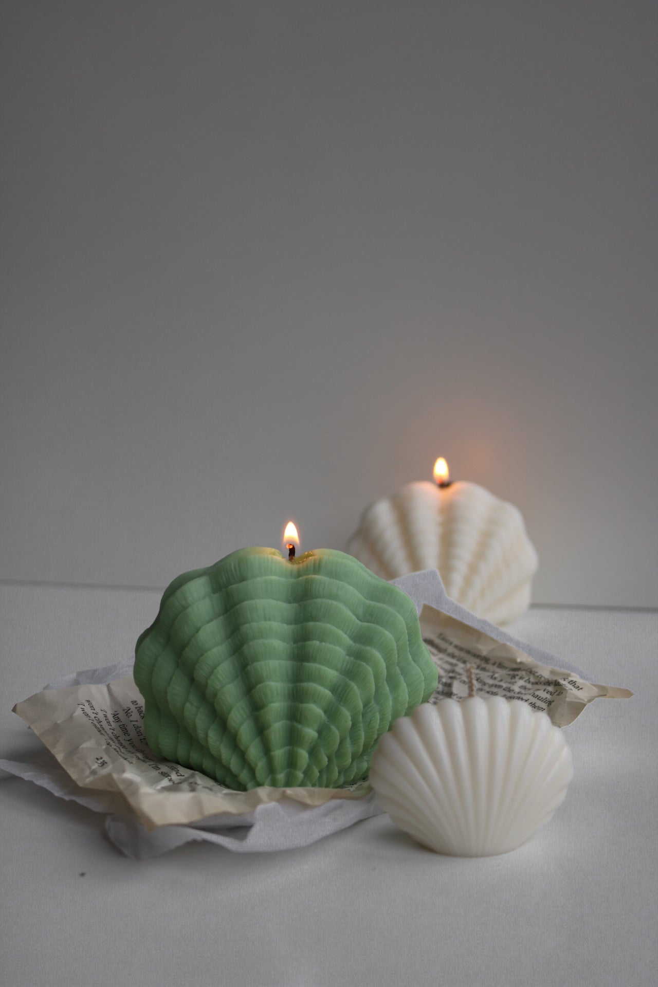 Large decorative shell candle with an elegant design, perfect for home decor.