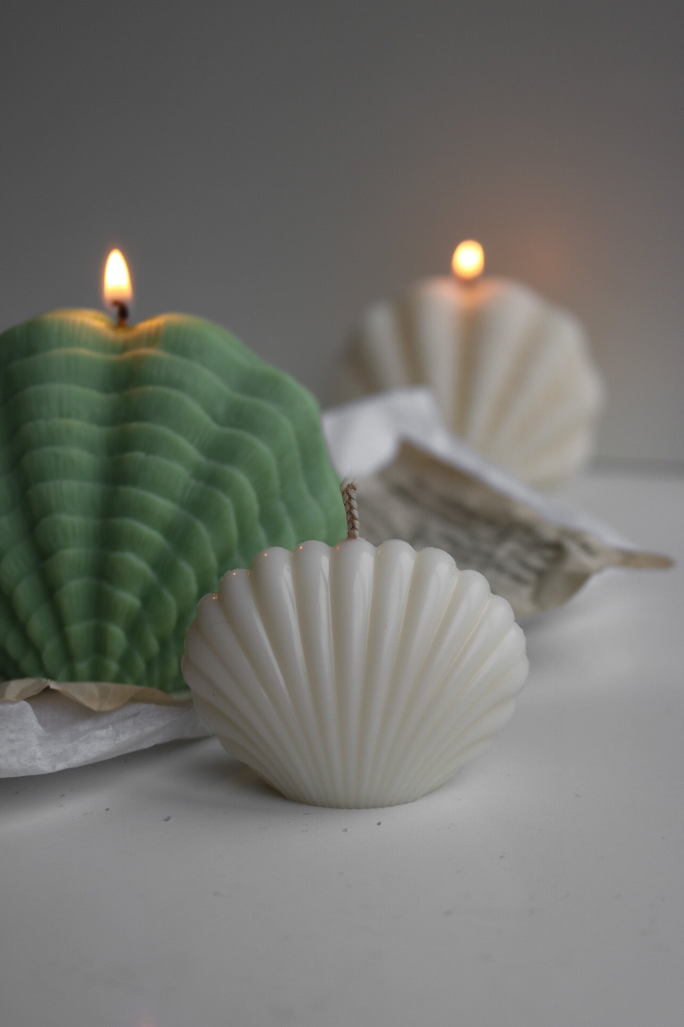 Large decorative shell candle with an elegant design, perfect for home decor.