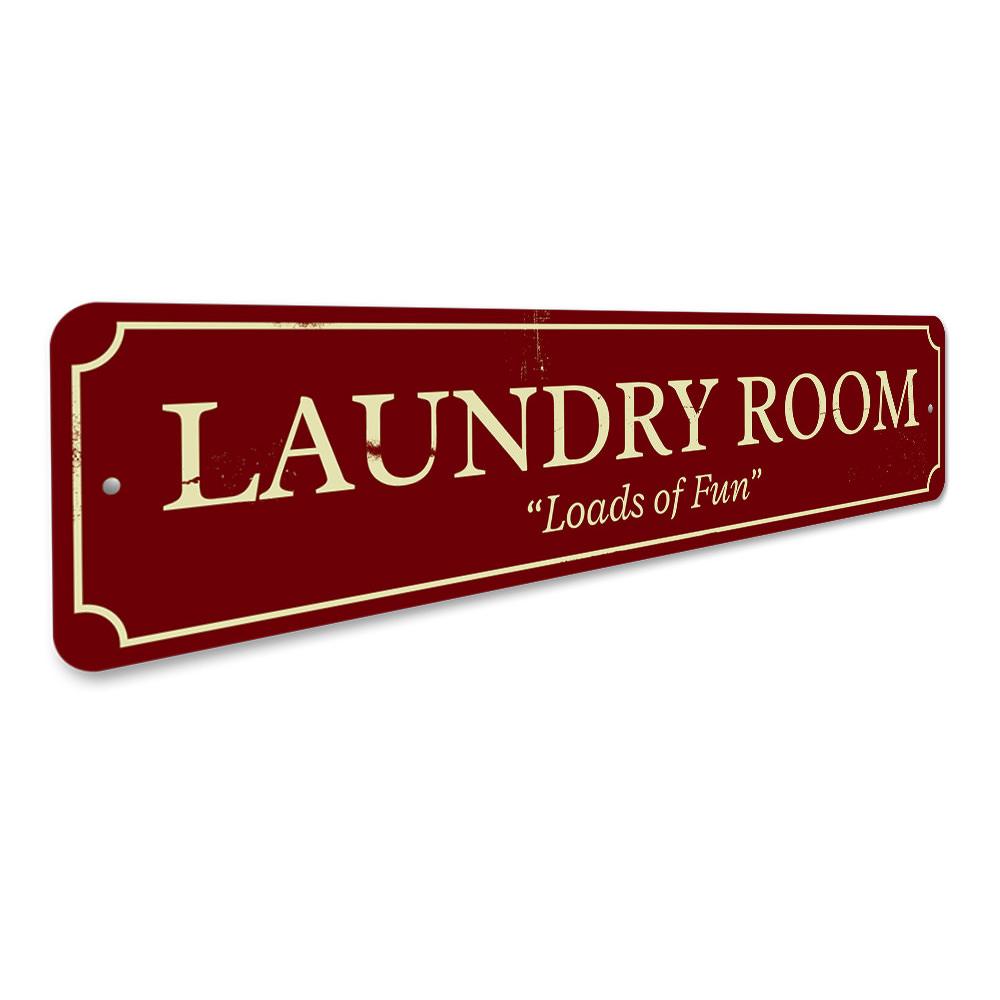 Laundry Room Loads of Fun Sign made of high-quality aluminum, featuring a playful design perfect for home decor.