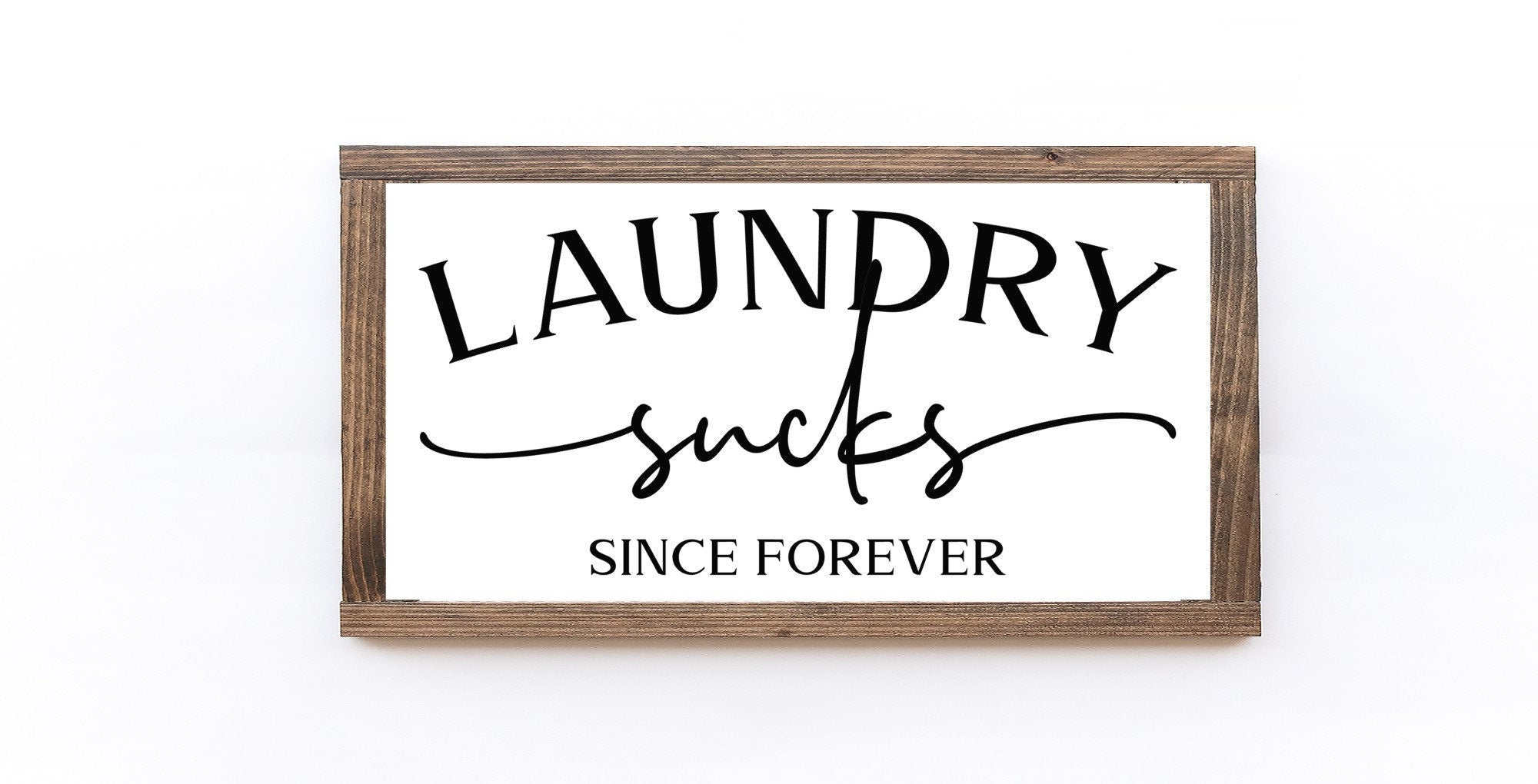 Laundry Sucks Since Forever Wood Sign in matte white finish, showcasing humorous lettering on a rustic wooden background.