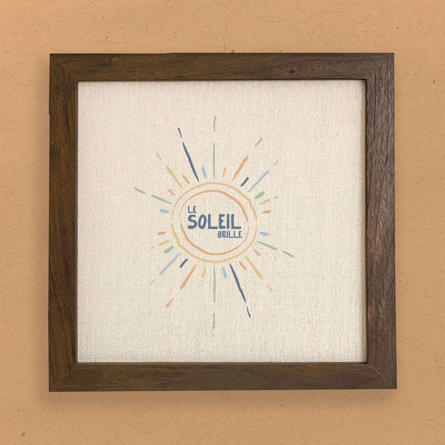 Le Soleil Brille framed sign featuring a stylized wood frame in walnut or white-washed finish with a linen-look background.