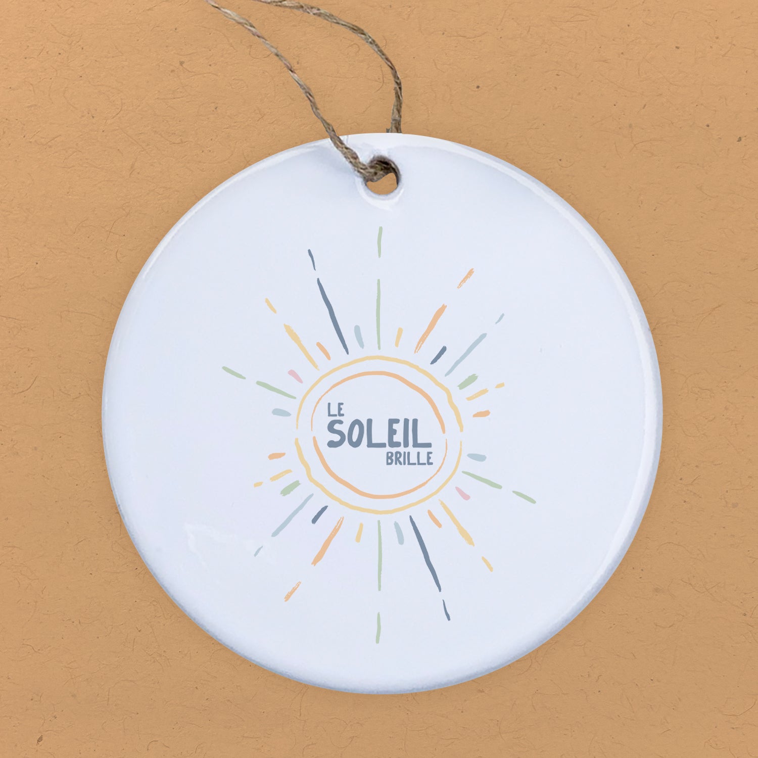 Le Soleil Brille ornament featuring a vibrant sun design on high-quality porcelain, perfect for gifting or decoration.