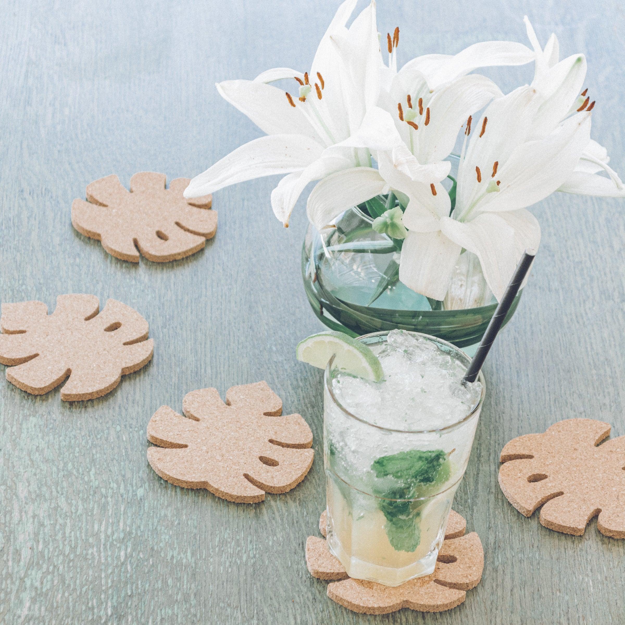 Set of six Monstera leaf shaped cork coasters, eco-friendly and stylish for home decor.