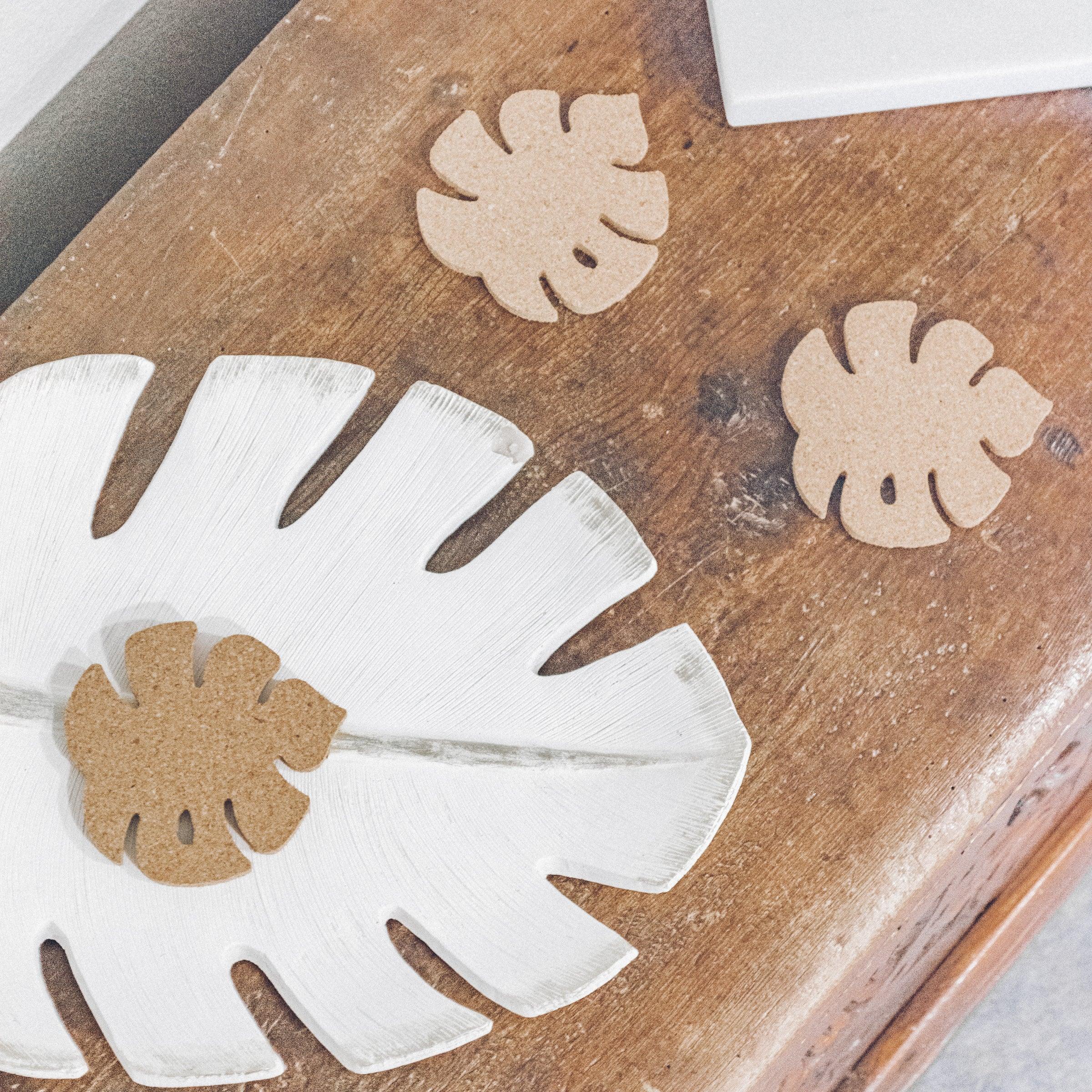 Set of six Monstera leaf shaped cork coasters, eco-friendly and stylish for home decor.