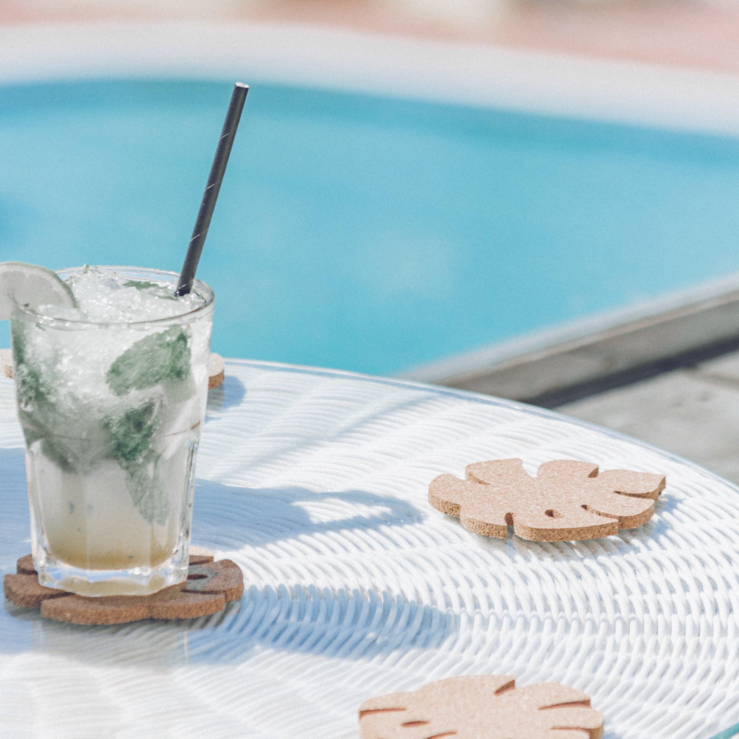 Set of six Monstera leaf shaped cork coasters, eco-friendly and stylish for home decor.