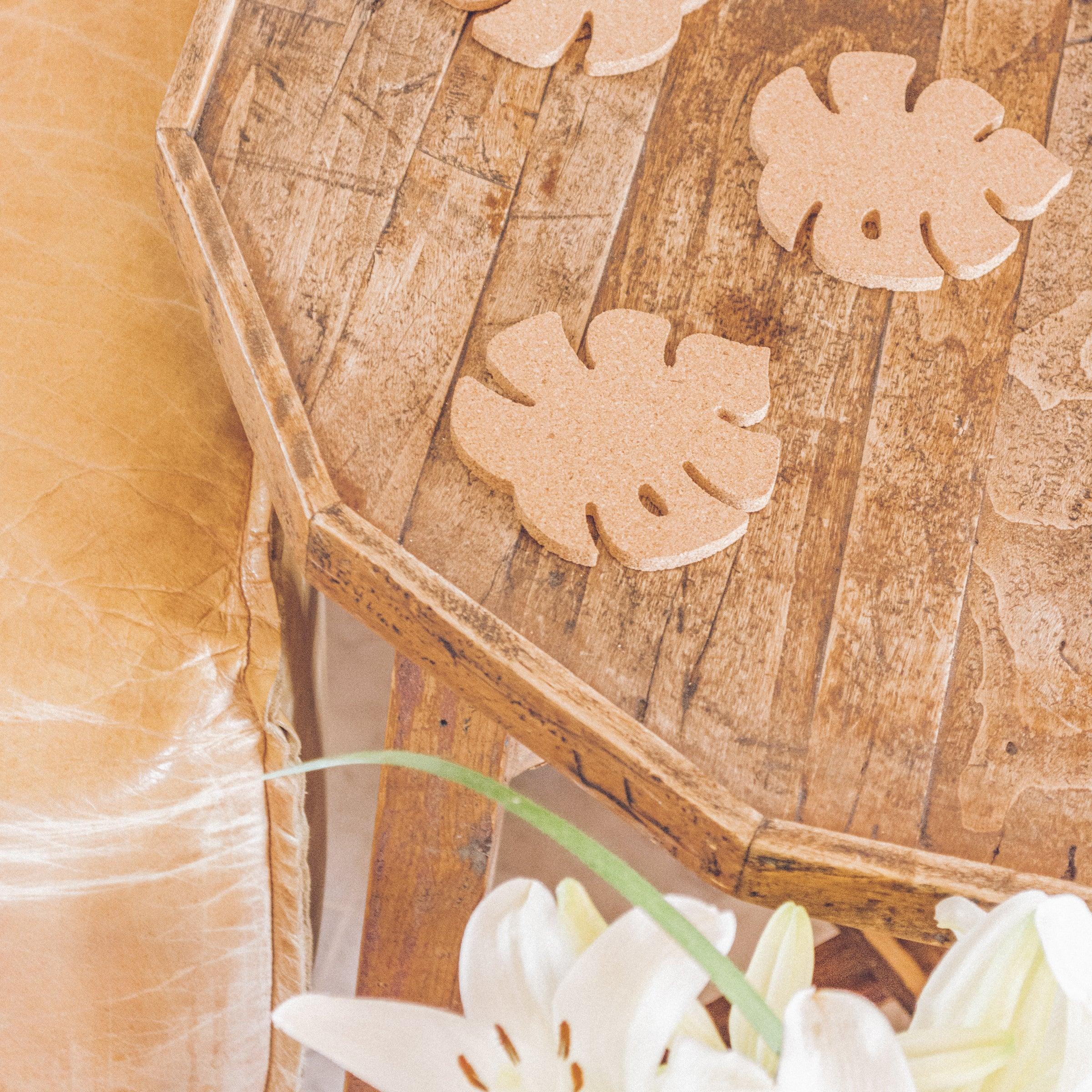 Set of six Monstera leaf shaped cork coasters, eco-friendly and stylish for home decor.