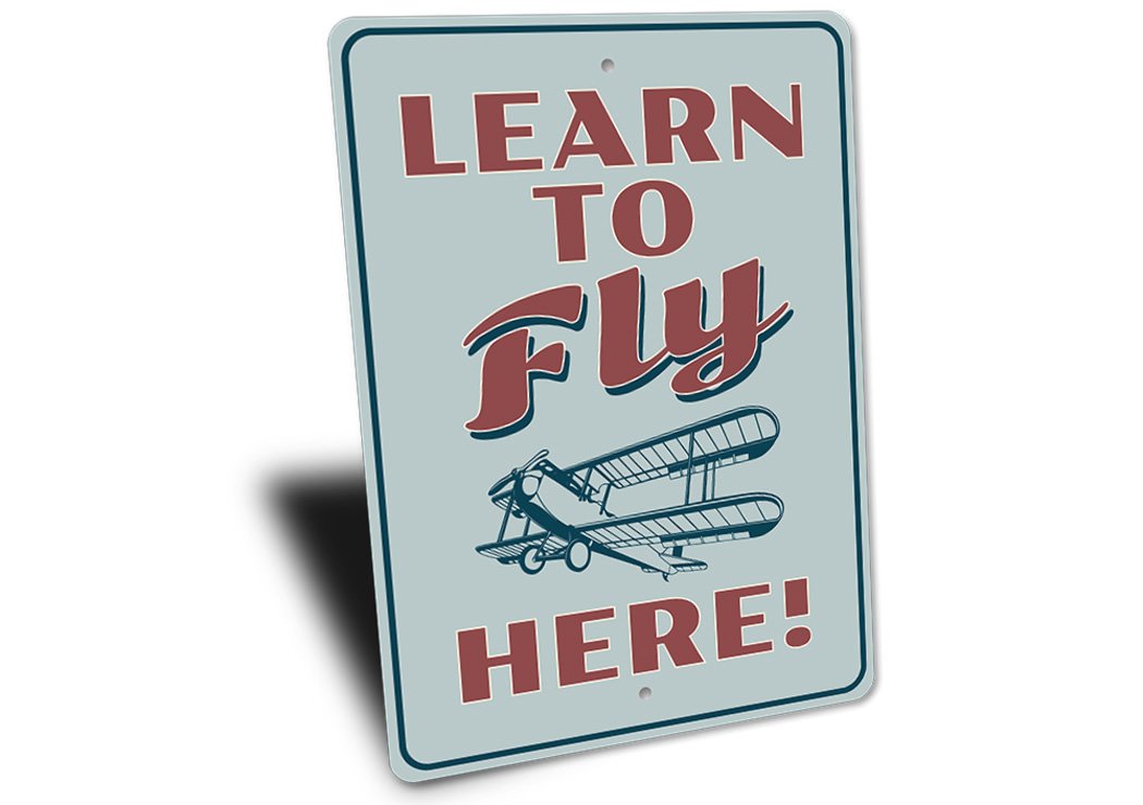 A decorative Learn to Fly Aviation Sign made of high-quality aluminum, featuring aviation-themed graphics and customizable text options.