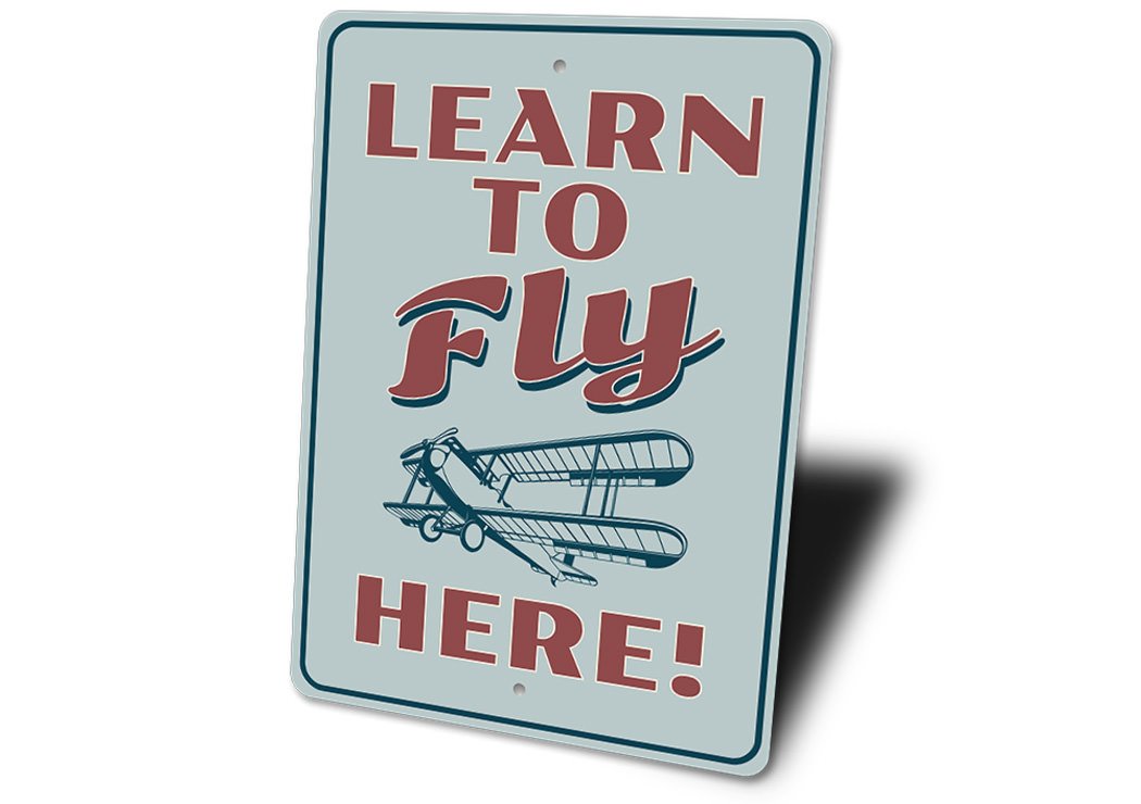 A decorative Learn to Fly Aviation Sign made of high-quality aluminum, featuring aviation-themed graphics and customizable text options.