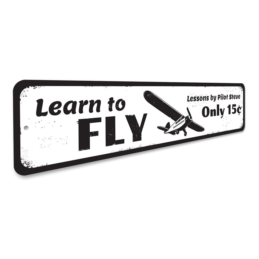 A decorative Learn To Fly Sign made of high-quality aluminum, featuring customizable text, ideal for home decor.