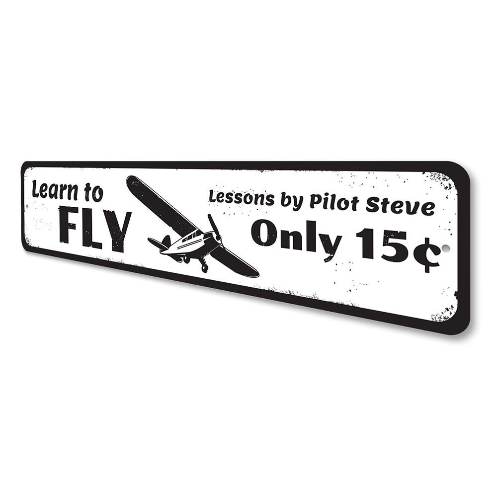 A decorative Learn To Fly Sign made of high-quality aluminum, featuring customizable text, ideal for home decor.