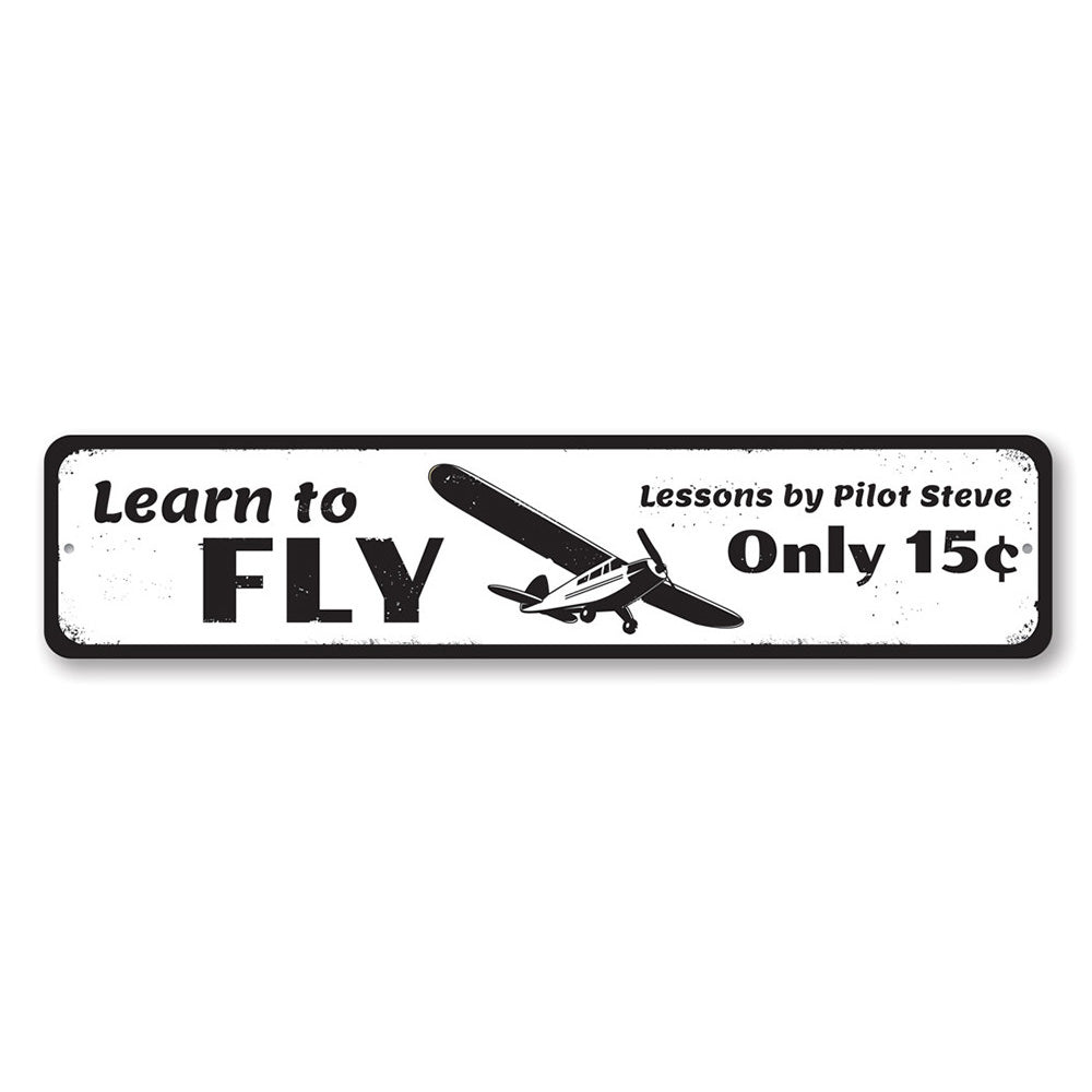 A decorative Learn To Fly Sign made of high-quality aluminum, featuring customizable text, ideal for home decor.