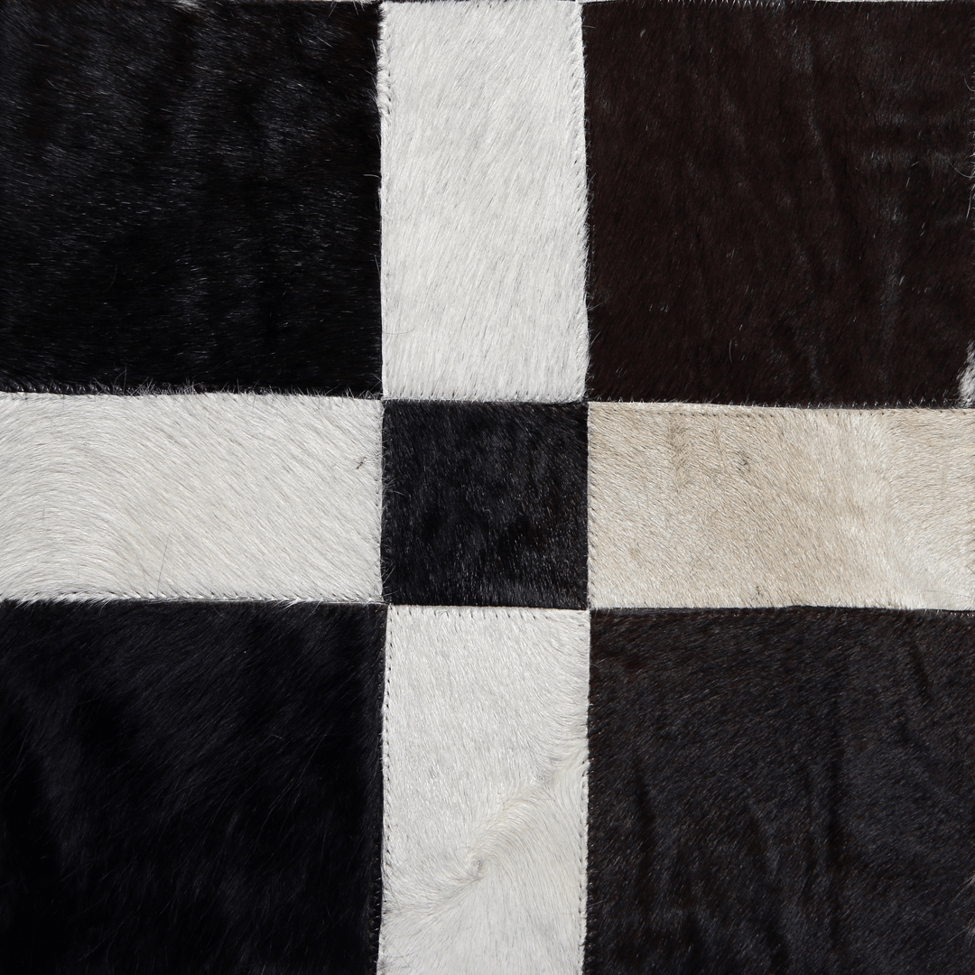 Handmade cowhide leather rug featuring a unique square patchwork design, showcasing natural textures and colors.